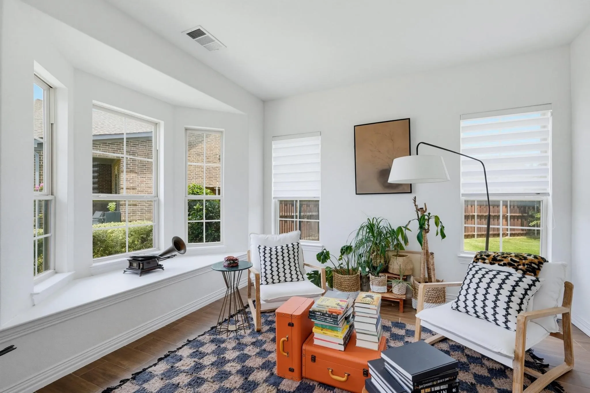Bright interior space featuring a multi-pane bay window with an integrated window seat
