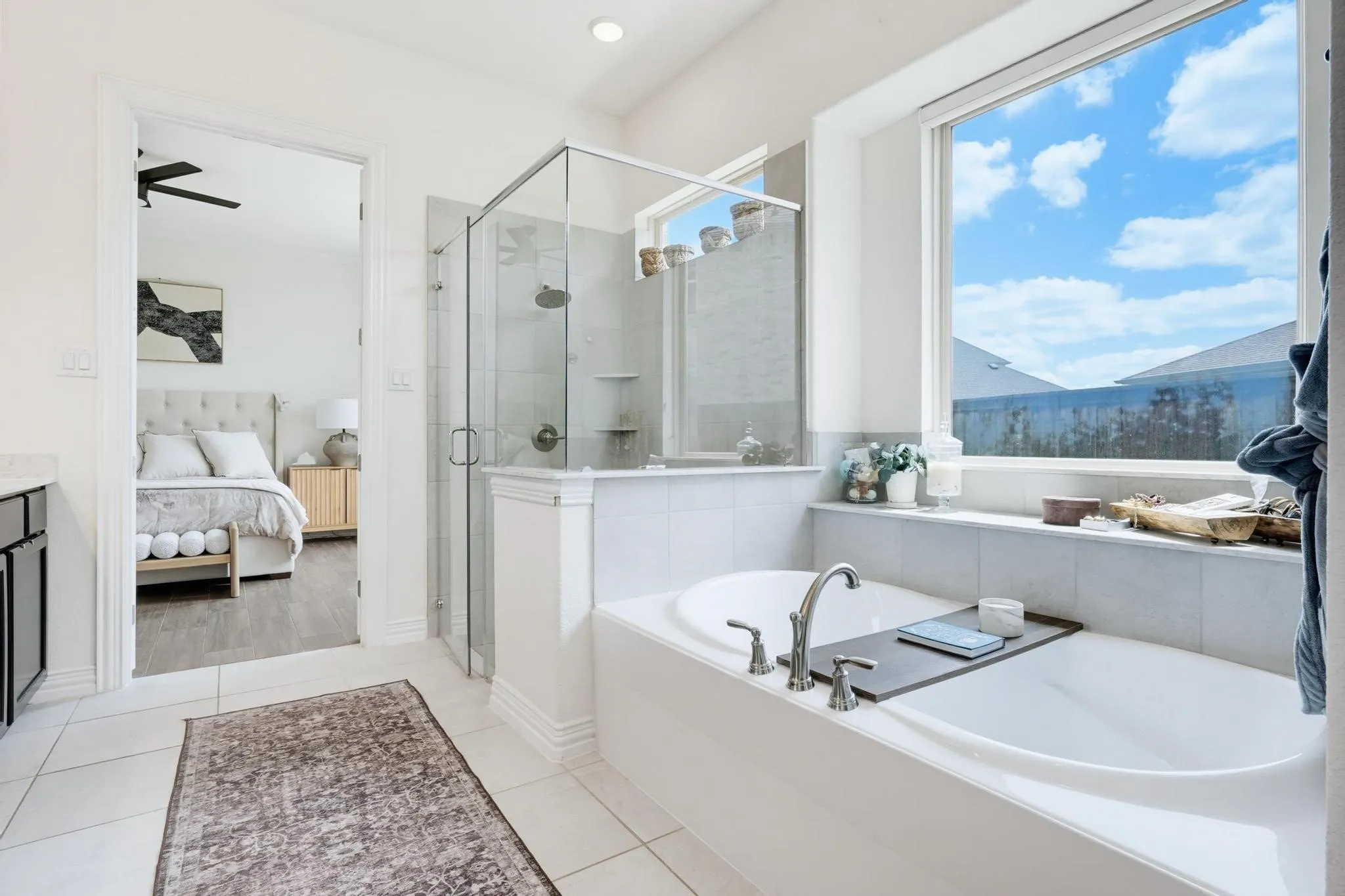 Soaking tub with deck-mounted faucet and an expansive window