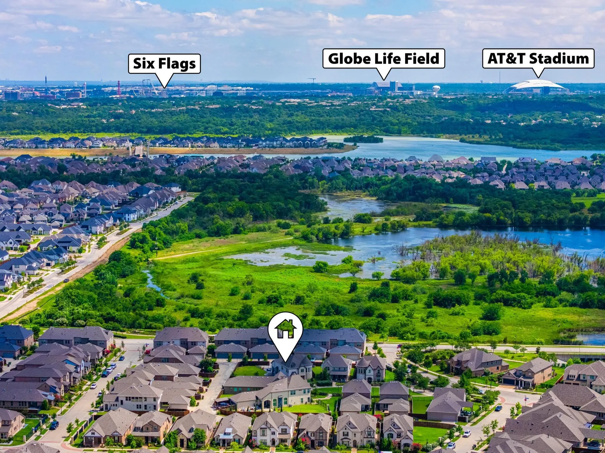 Aerial perspective showcasing a residential development with natural water features and green spaces