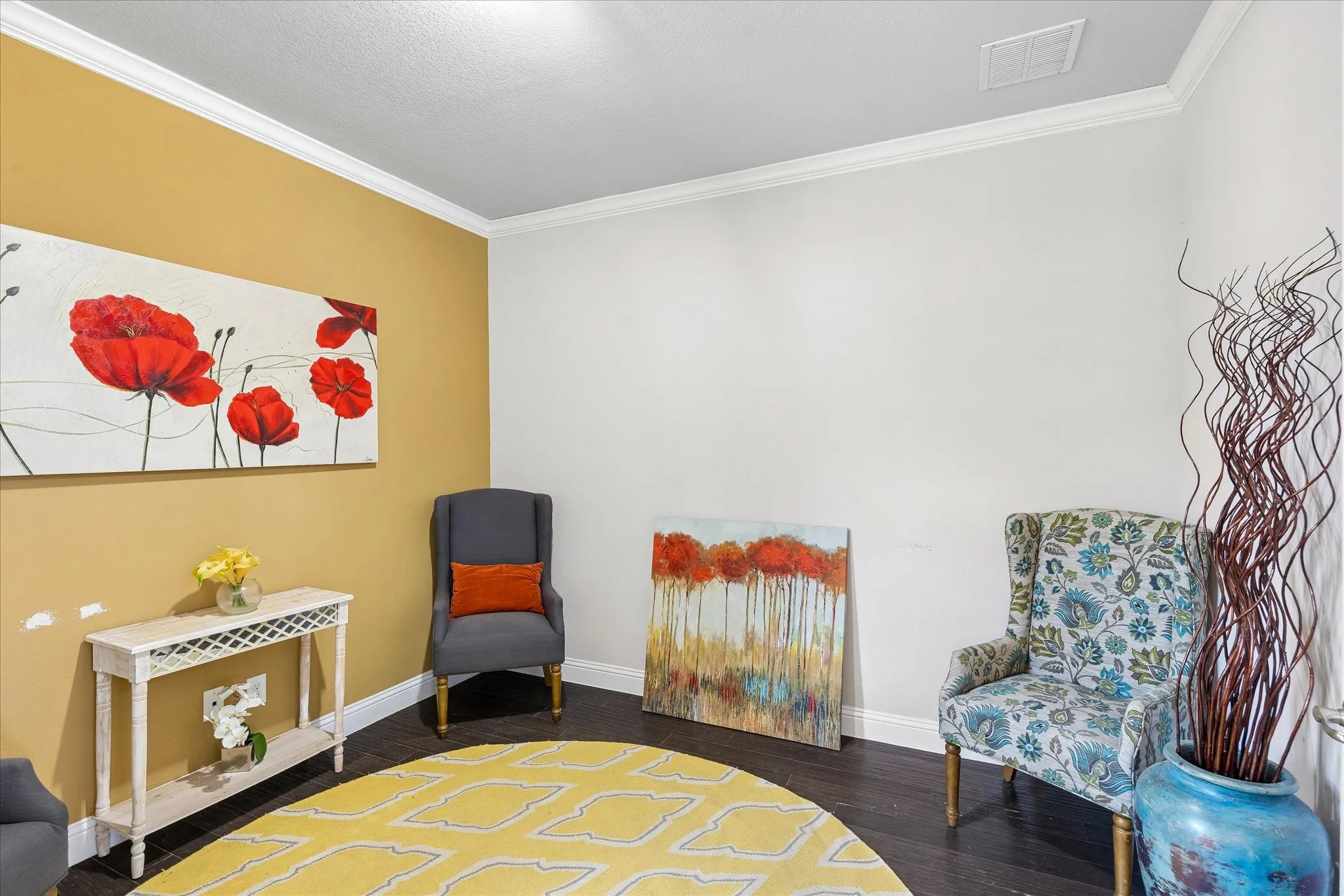 Interior room with dark wood-finish flooring, white crown molding, and contrasting wall colors