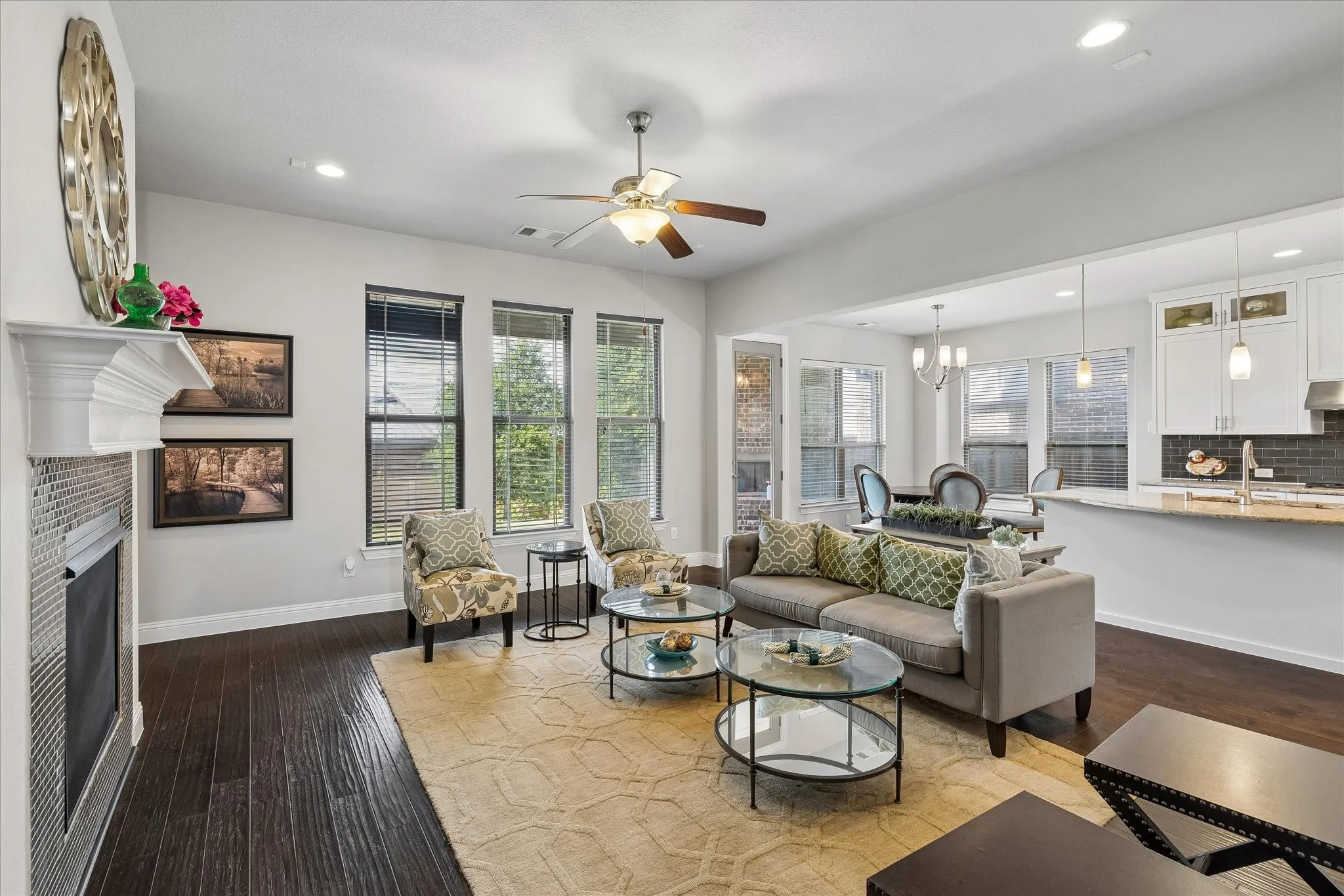 Living area featuring dark wood-finish flooring, recessed lighting, and a ceiling fan