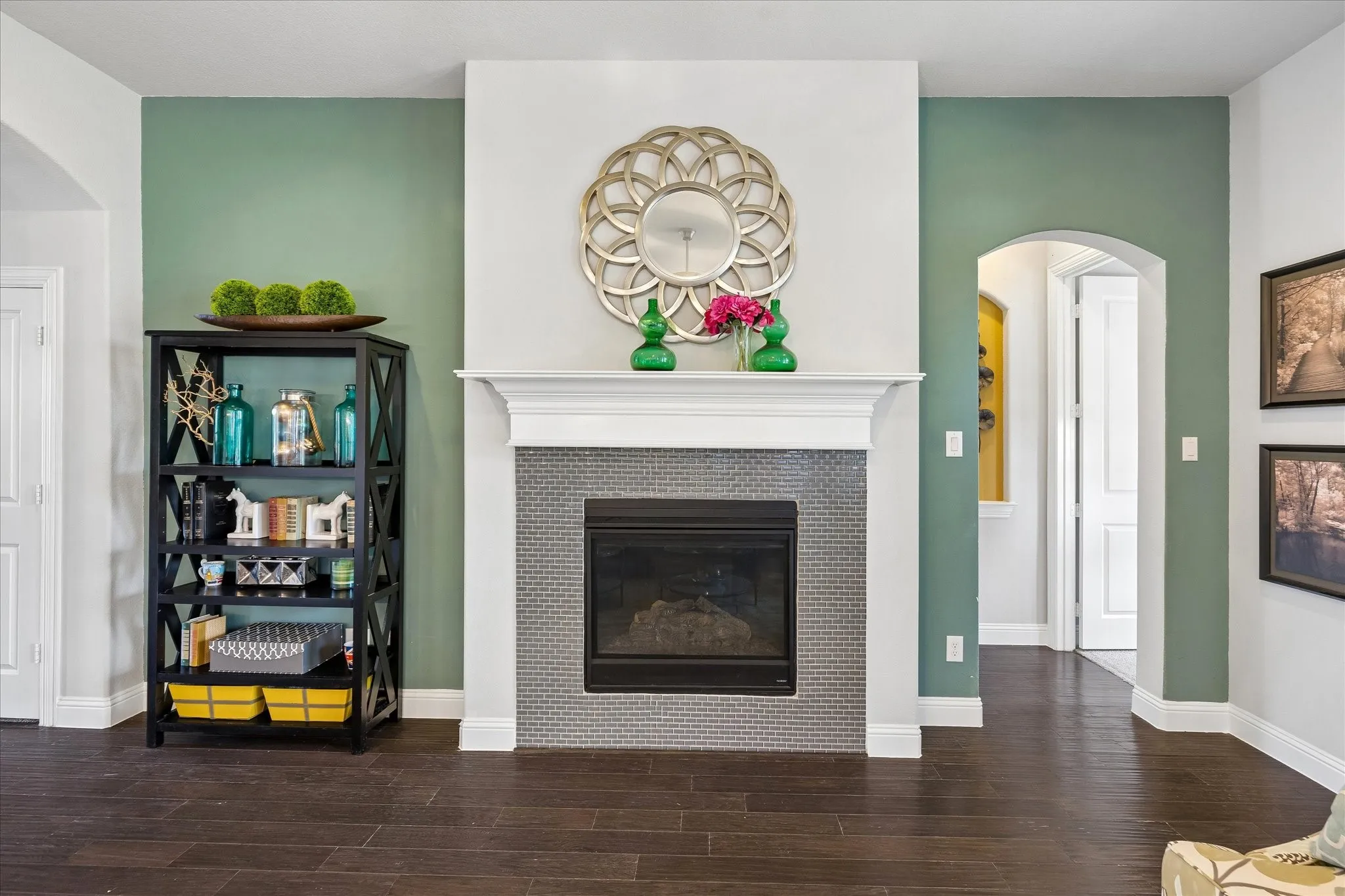 Fireplace featuring a mosaic tile surround and a classic white mantel
