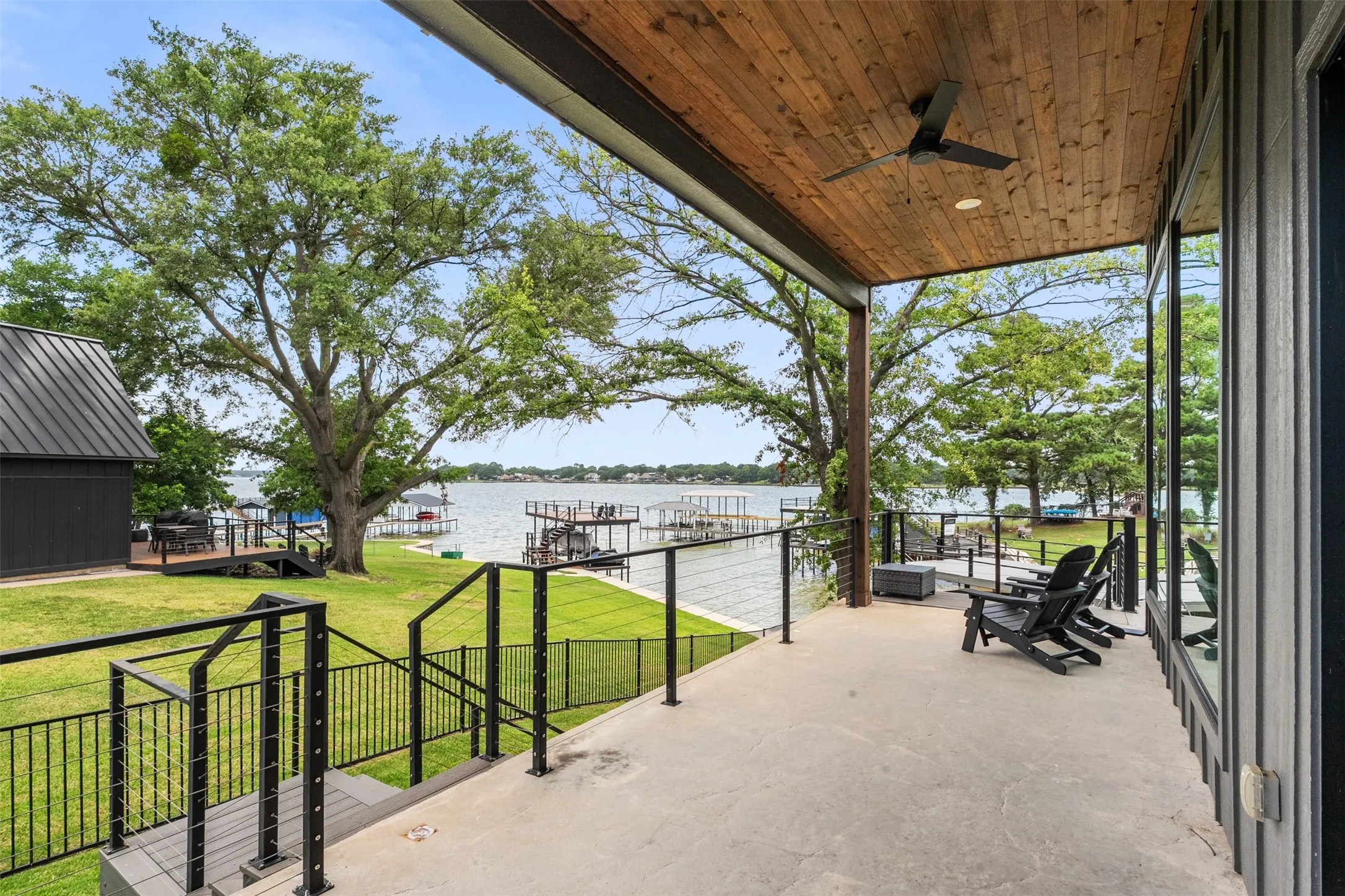 Covered patio with a wood plank ceiling and integrated ceiling fan