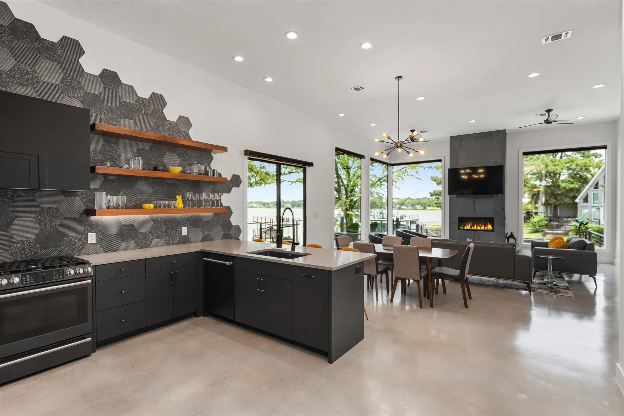 Open-concept main living area featuring a modern kitchen, dining space, and living room