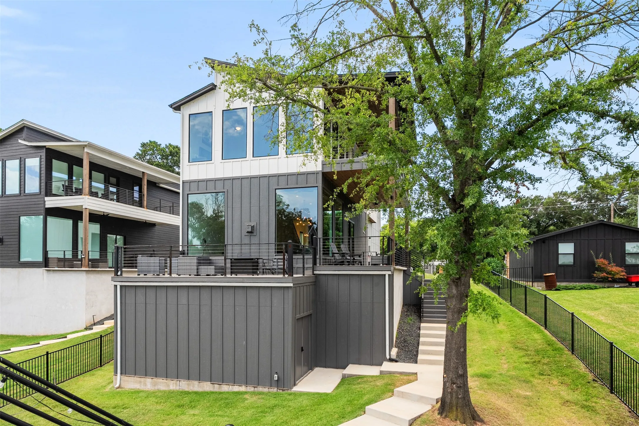 Contemporary multi-level residence featuring a contrasting white and dark gray exterior