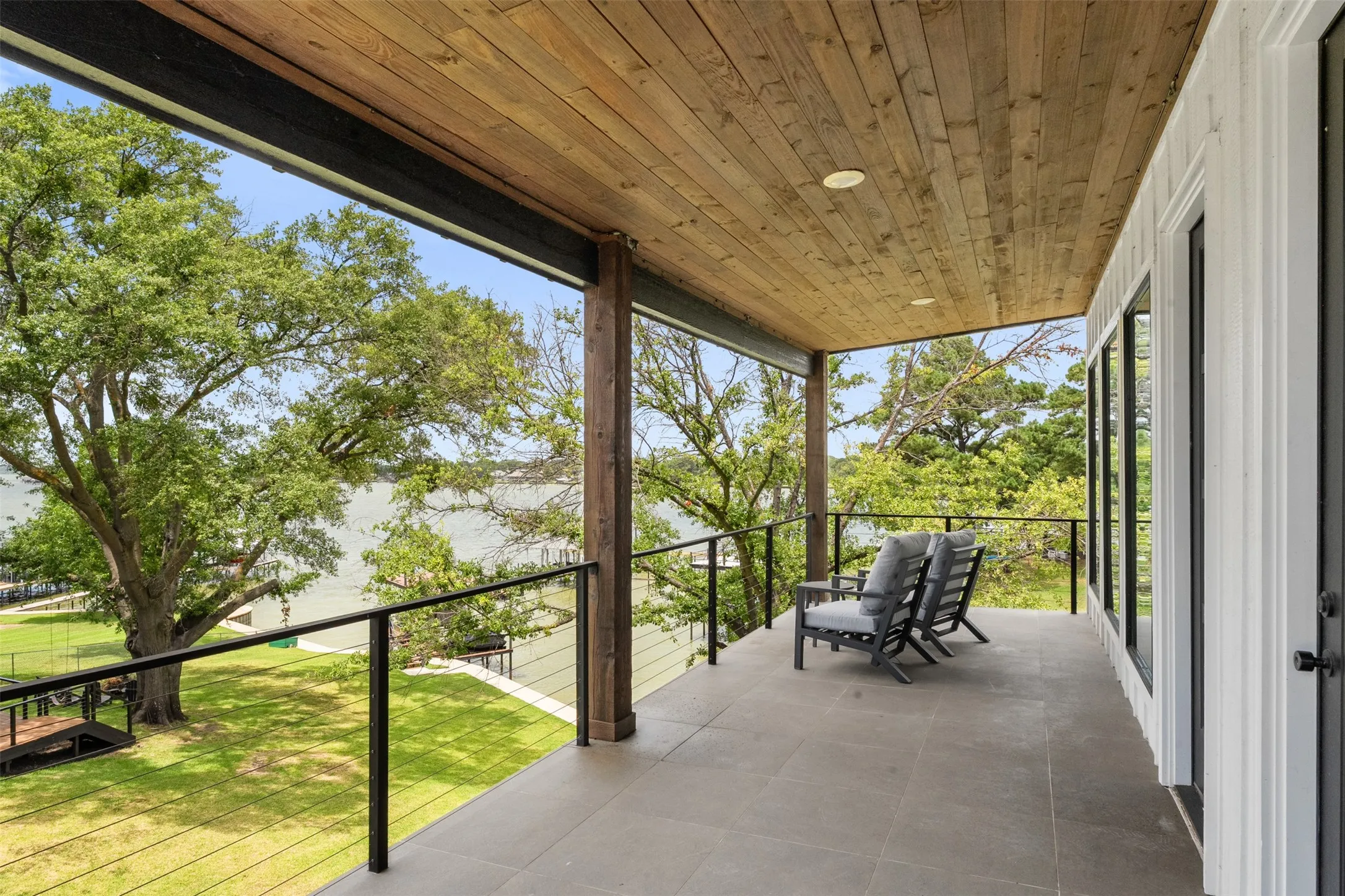 Covered outdoor terrace featuring a wood-plank ceiling with recessed lighting