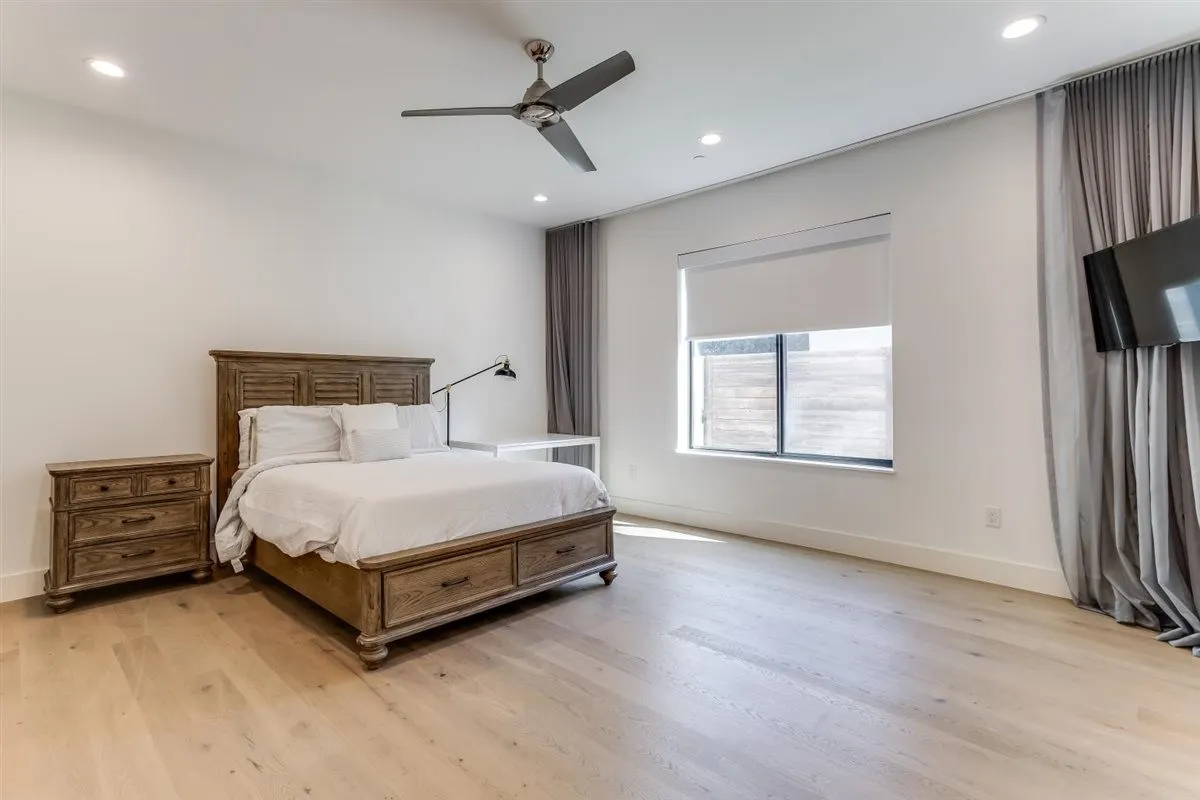 Spacious room featuring light wood-finish flooring, recessed lighting, and a contemporary ceiling fan