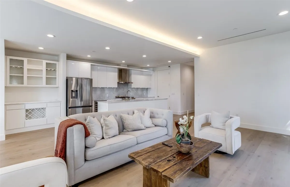 Open-concept living space featuring wood-finish flooring and recessed lighting