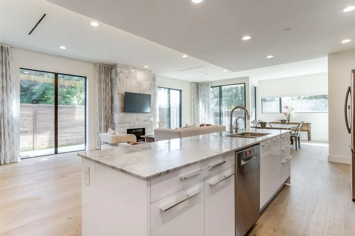 Contemporary kitchen island with a stone countertop and integrated sink