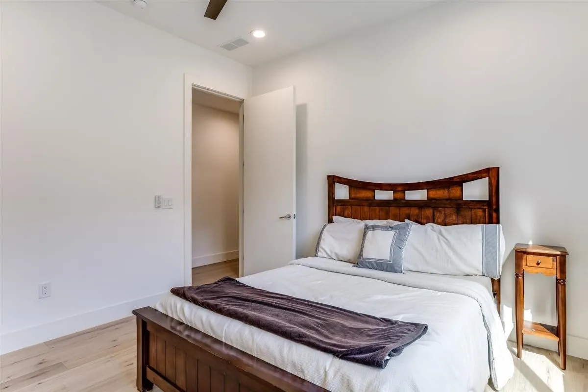 Bedroom featuring light wood-finish flooring, recessed lighting, and a ceiling fan