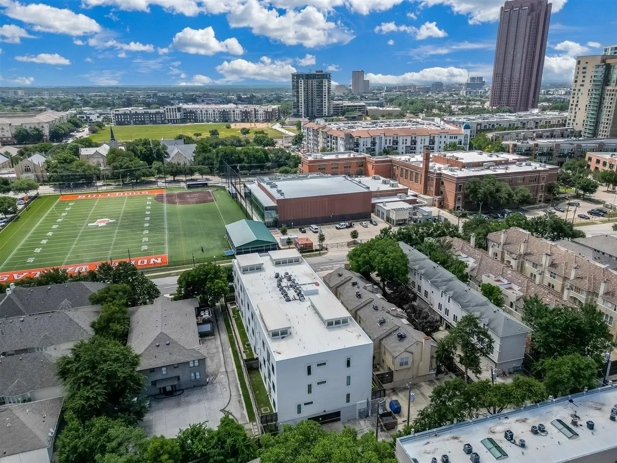 Aerial perspective showcasing a modern multi-story building within an urban setting