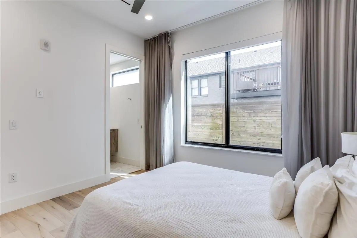 Recessed lighting illuminates wood-finish flooring
