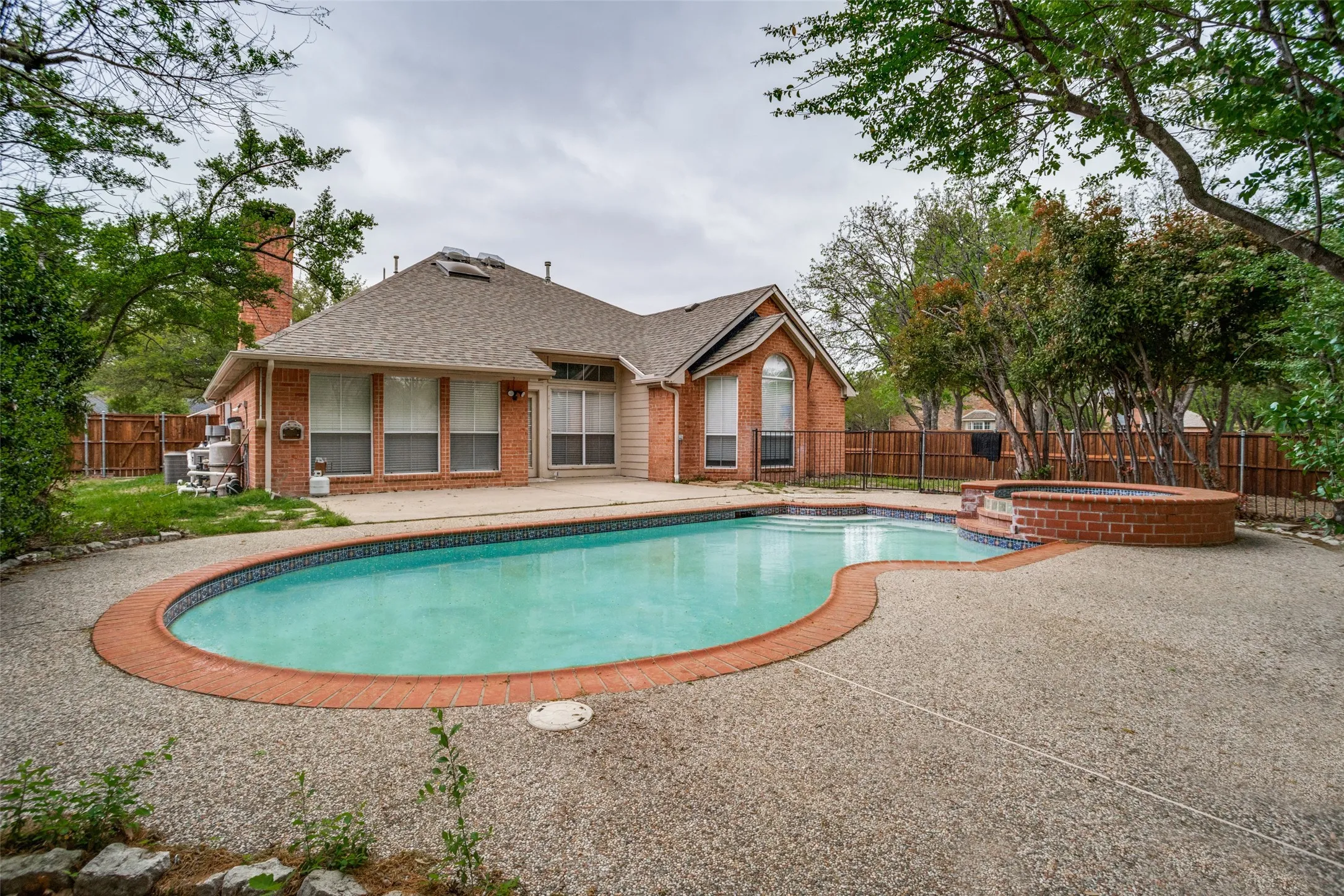 Relaxing pool / spa featuring a fenced backyard and a patio
