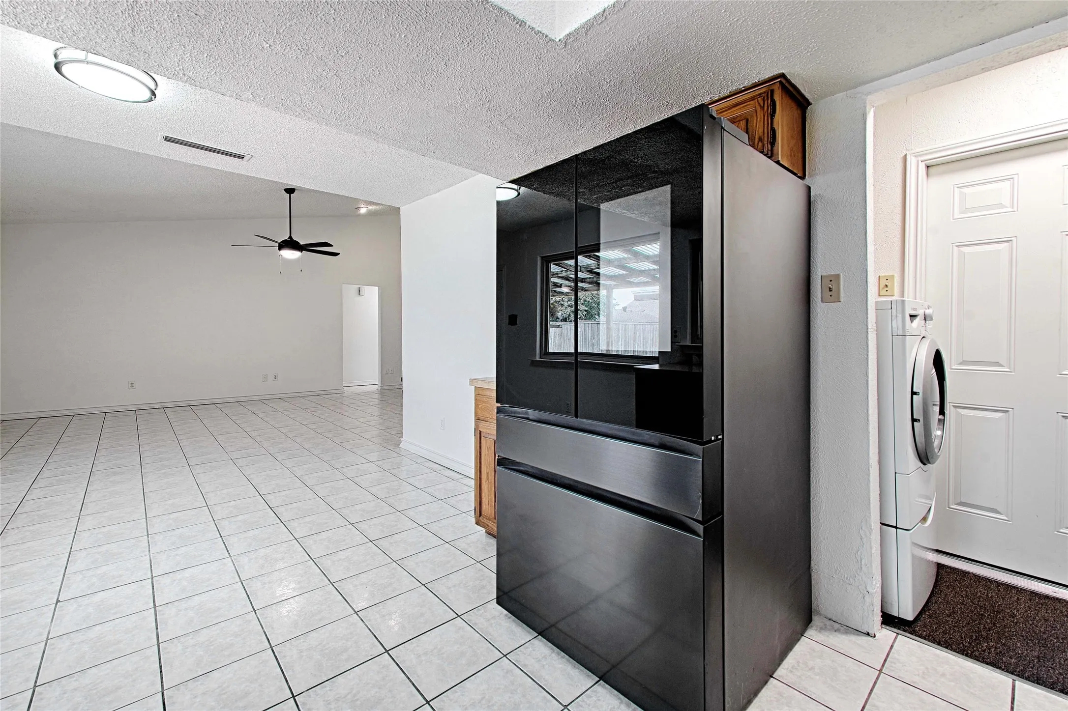 Bright interior space featuring light-toned square tile flooring throughout