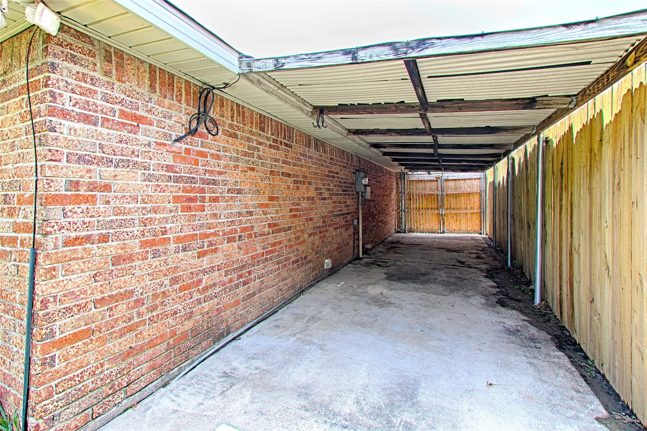 Covered concreted carport great for boat storage, gardening tools, toys, etc.