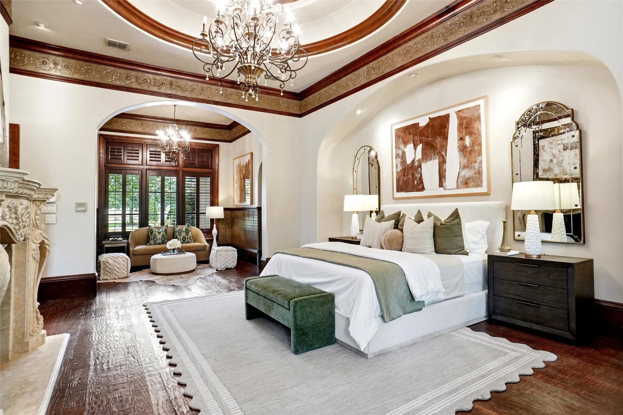 Vaulted ceiling with ornate wood trim and a central chandelier