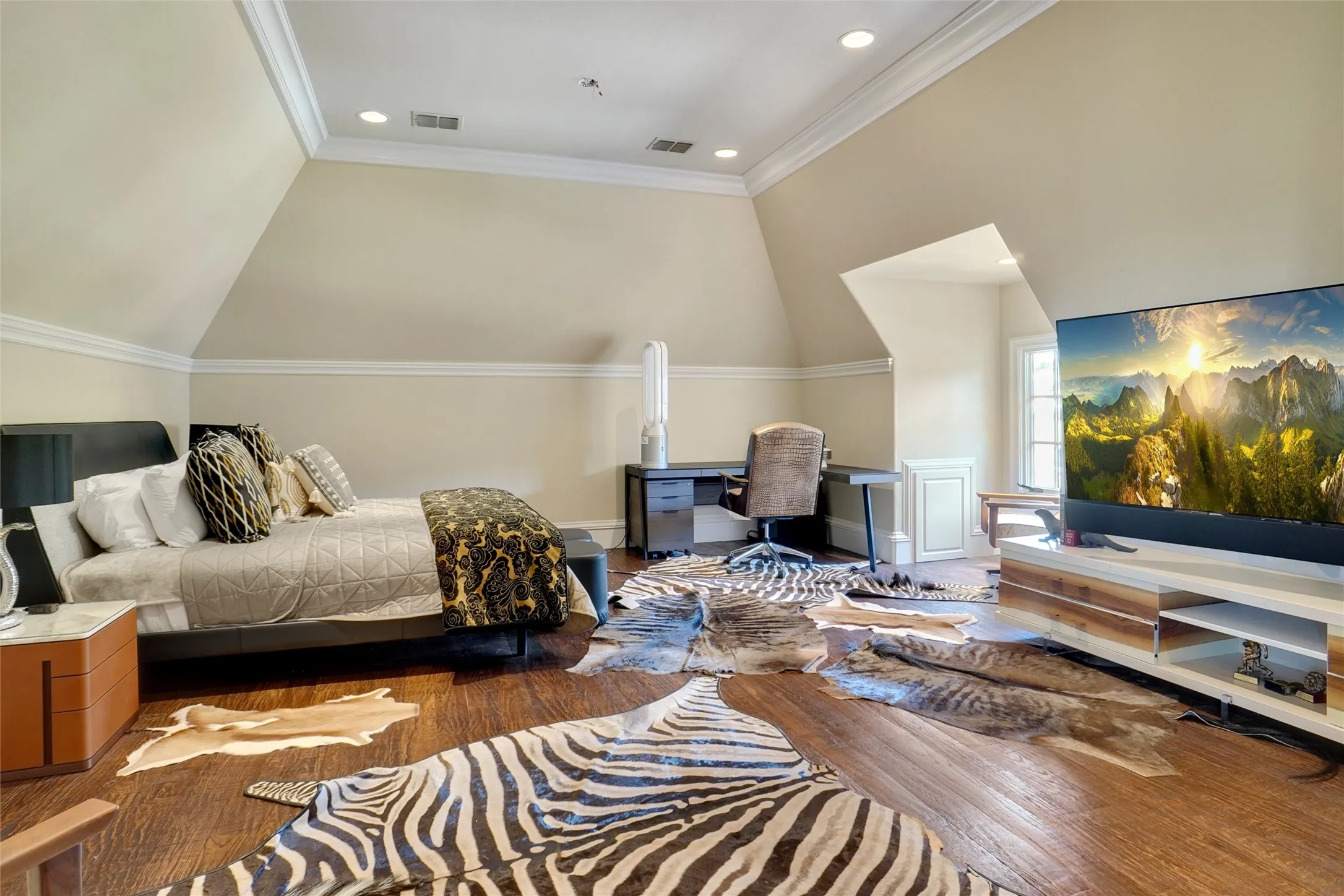 Additional bedroom featuring vaulted ceilings, recessed lighting, crown molding, and wood-finish flooring.