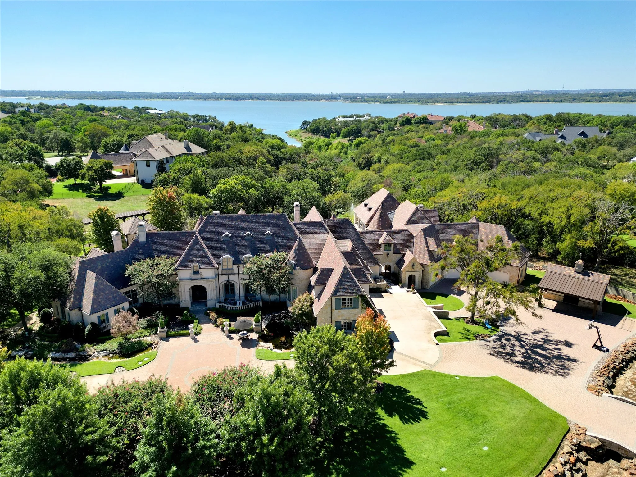 Gorgeous estate spanning over 4 acres with views of Grapevine Lake. Upon entering through the iron private gate you are greeted with a circular driveway, that leads you to the main residence.