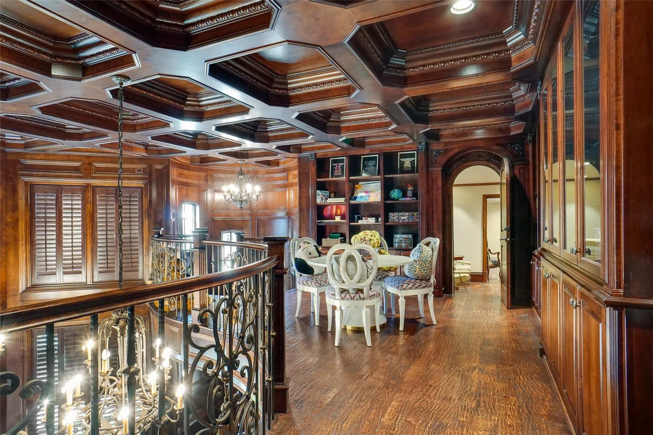 Second level loft space above the library has decorative tray/coffered ceilings. An iron circular staircase leads you to this loft. This wooden door shown here leads to a complete second residence.