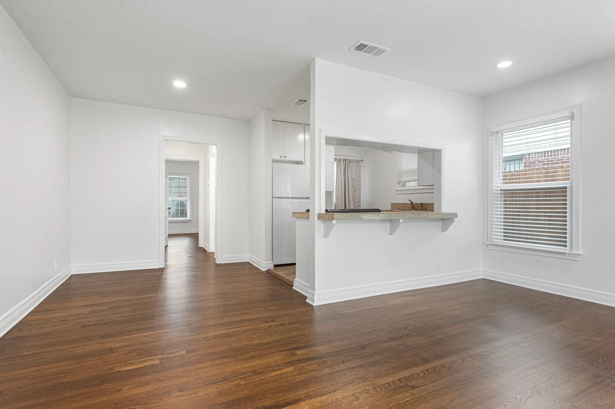 From Living Room, Walk Through Hall With Stacked Washer/Dryer In Closet To Bedroom At Back Of House.
