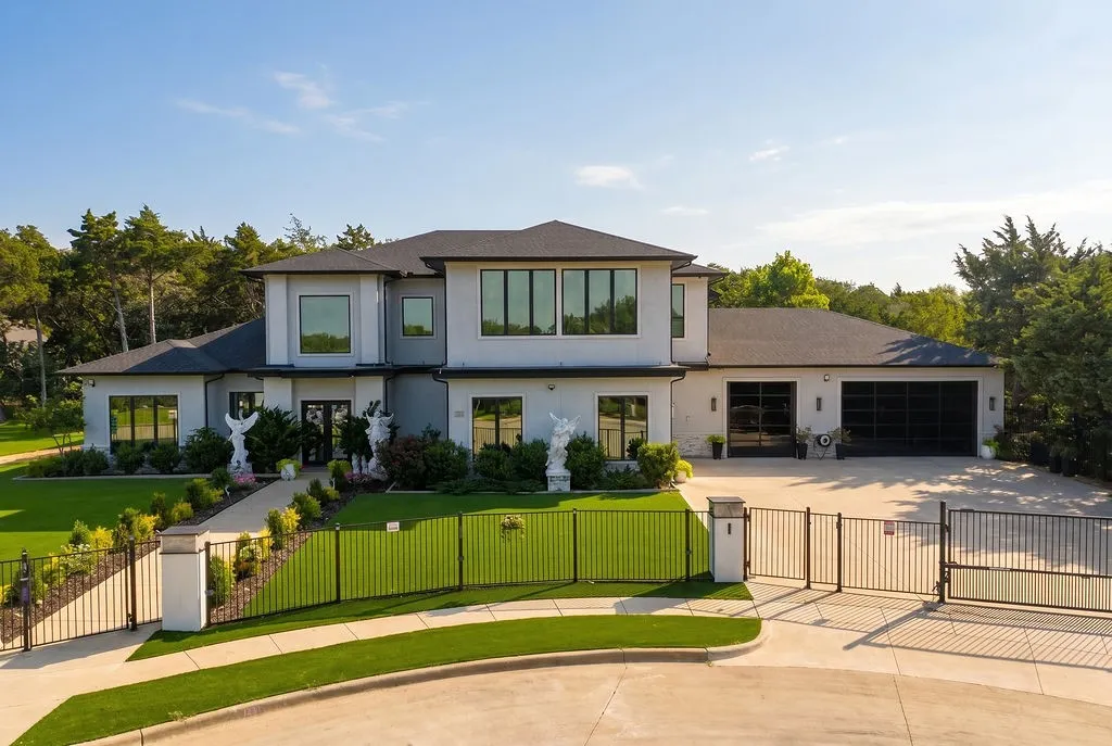 Contemporary two-story residence featuring a light gray exterior with dark trim accents