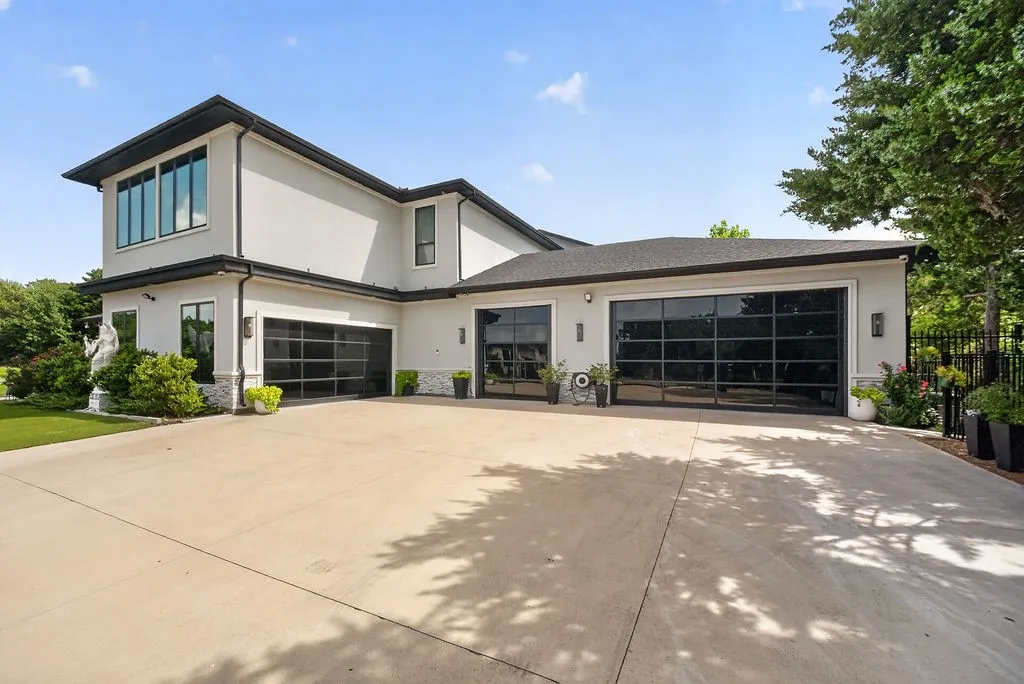 Contemporary stucco exterior with multiple full-view garage doors