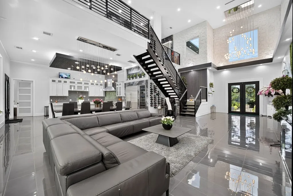 Soaring ceilings define this expansive interior, featuring polished tile flooring throughout