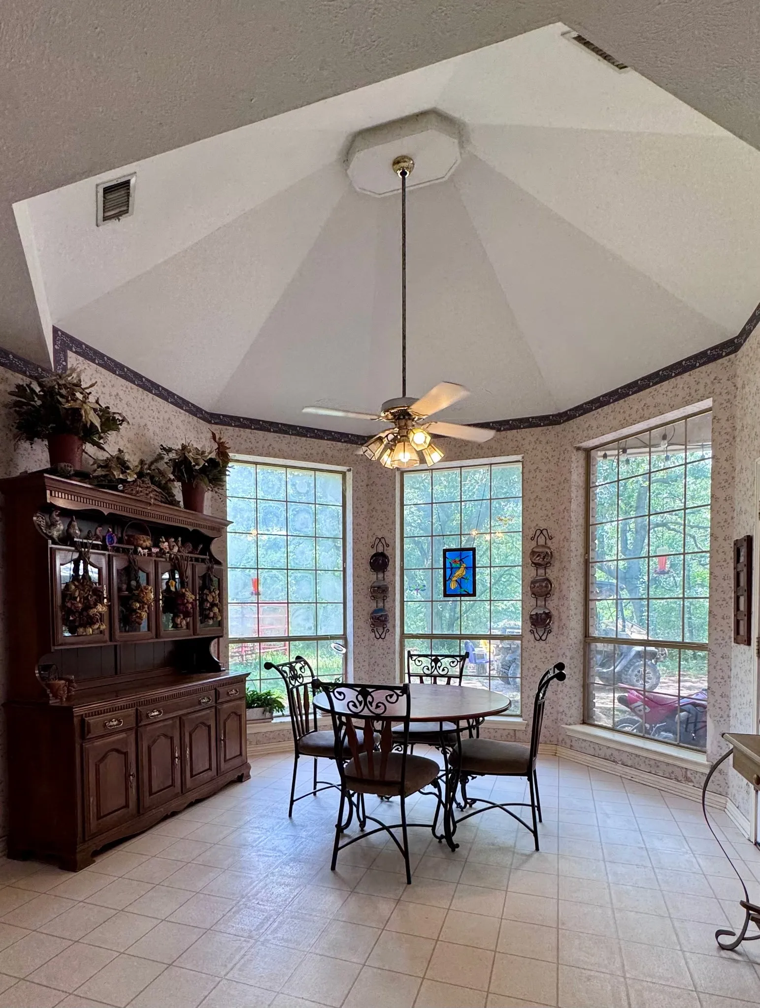 Octagonal vaulted ceiling featuring a central ceiling fan with integrated lighting