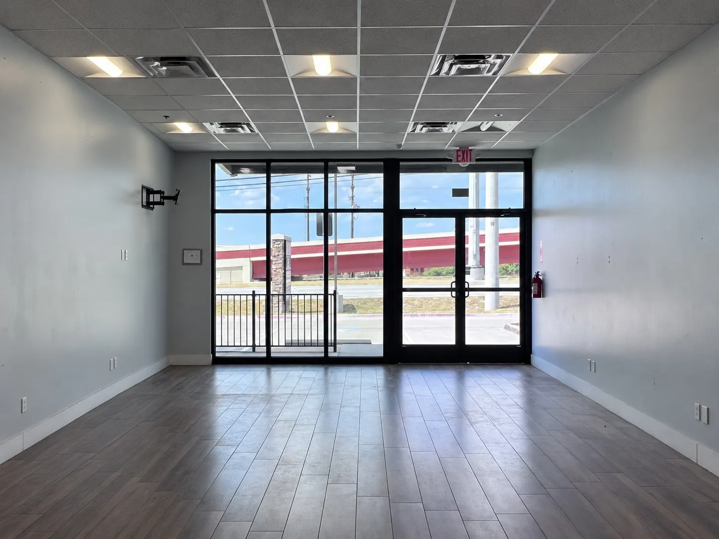 Light wood-finish flooring with white baseboards