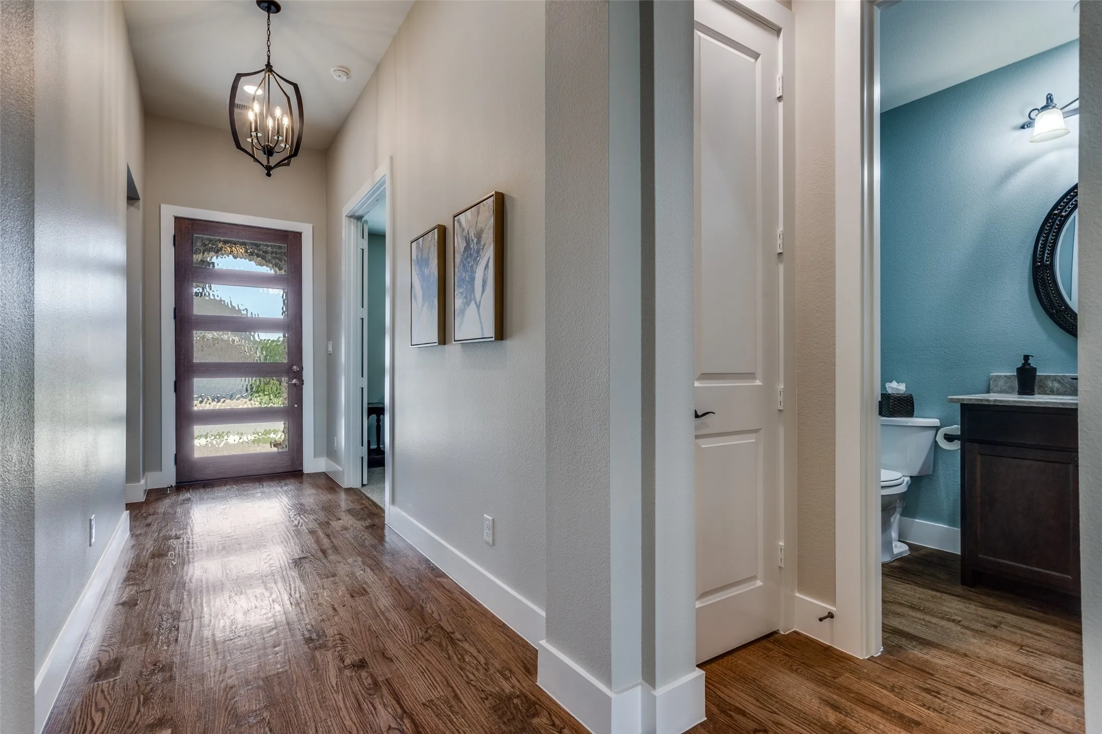 Beautiful entry with modern glass front door and upgraded lighting