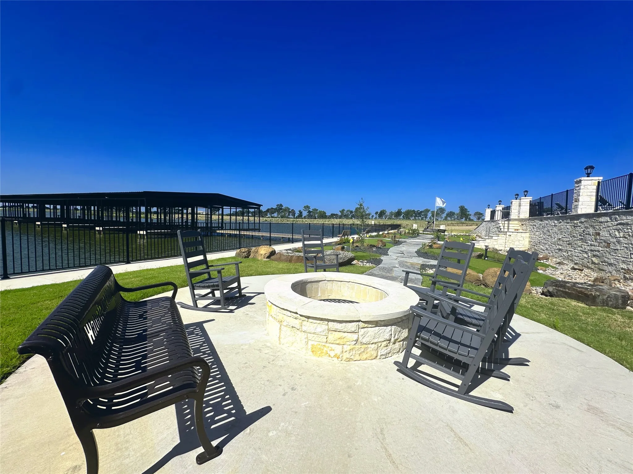 Community fire pit overlooking the water, perfect for gathering with neighbors and friends.