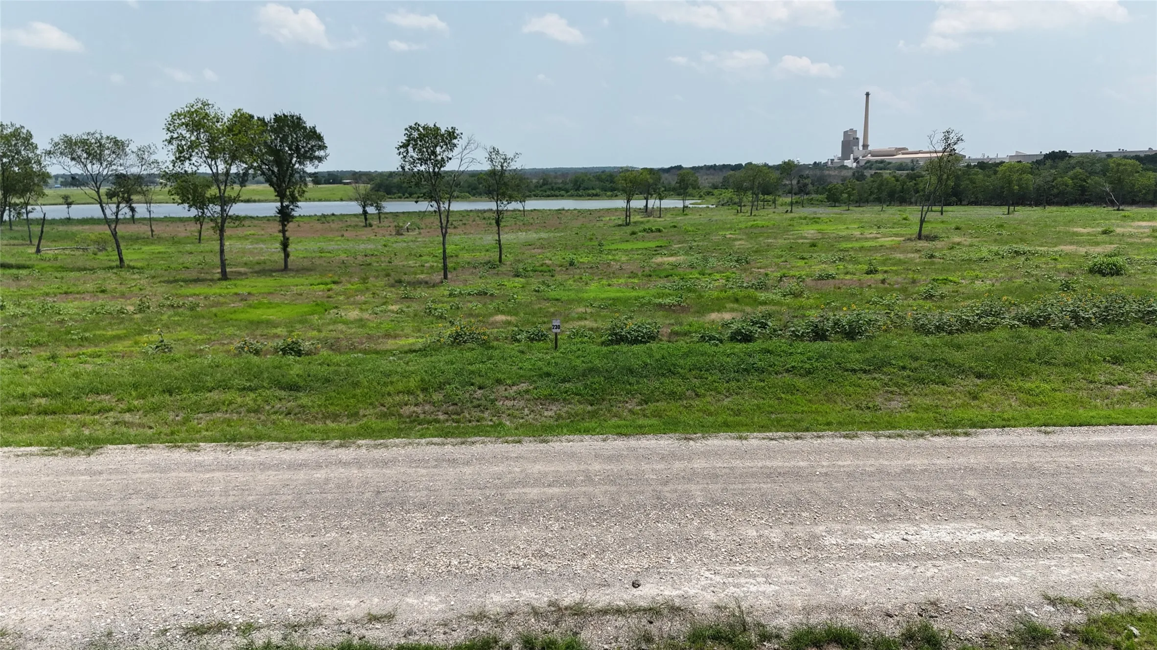 View from the road showing the property's accessibility and open terrain.