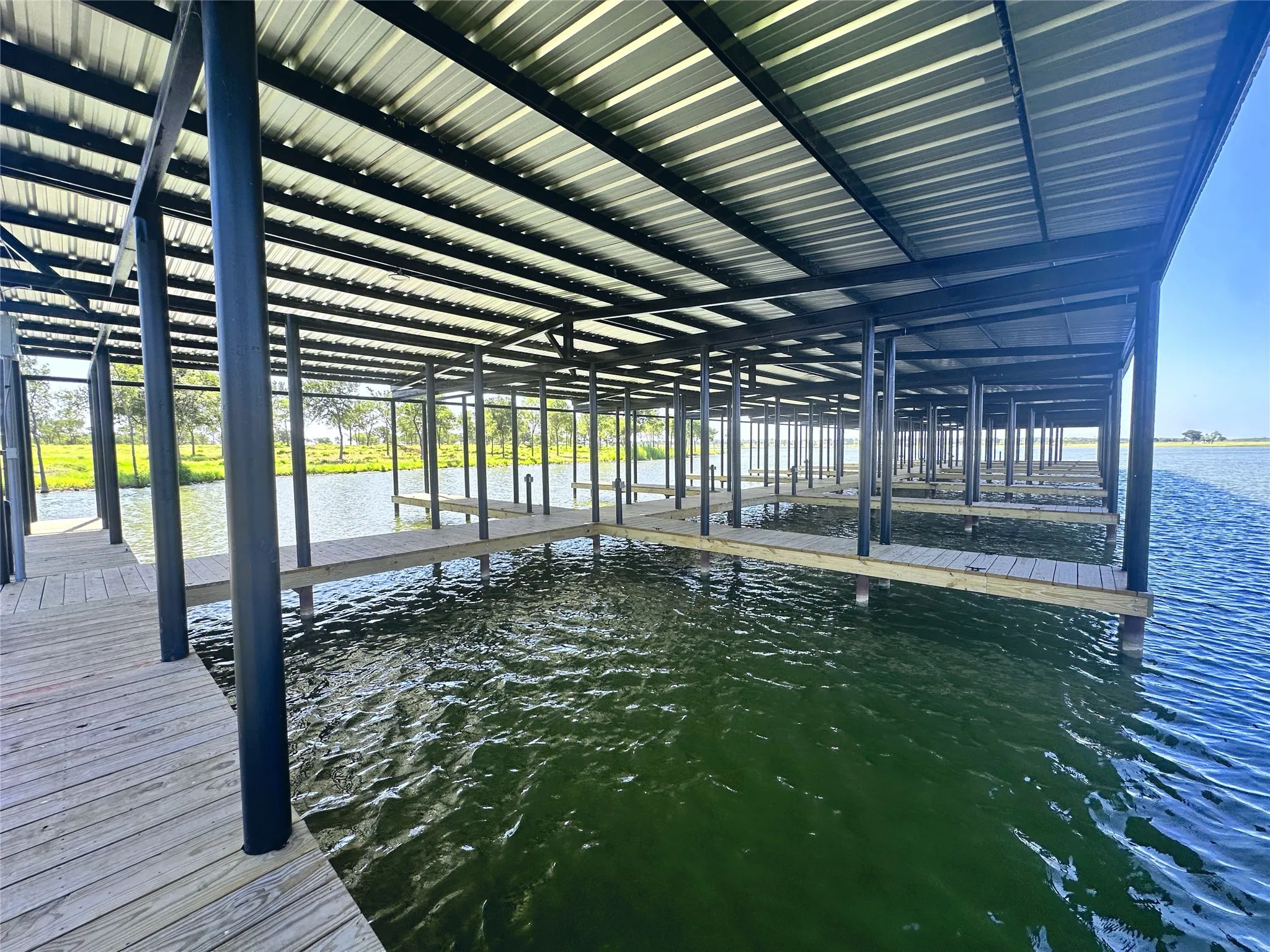 Interior view of the marina featuring multiple covered boat slips.