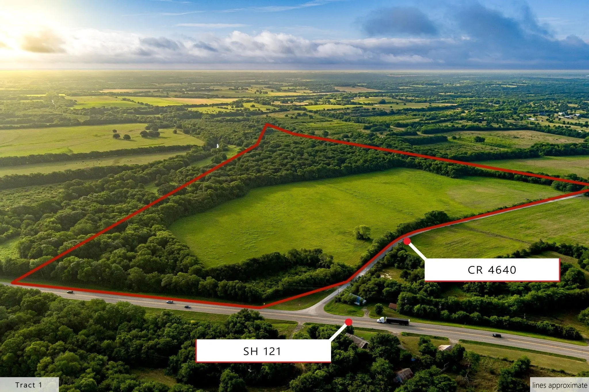 Expansive acreage featuring a mix of open fields and mature tree lines