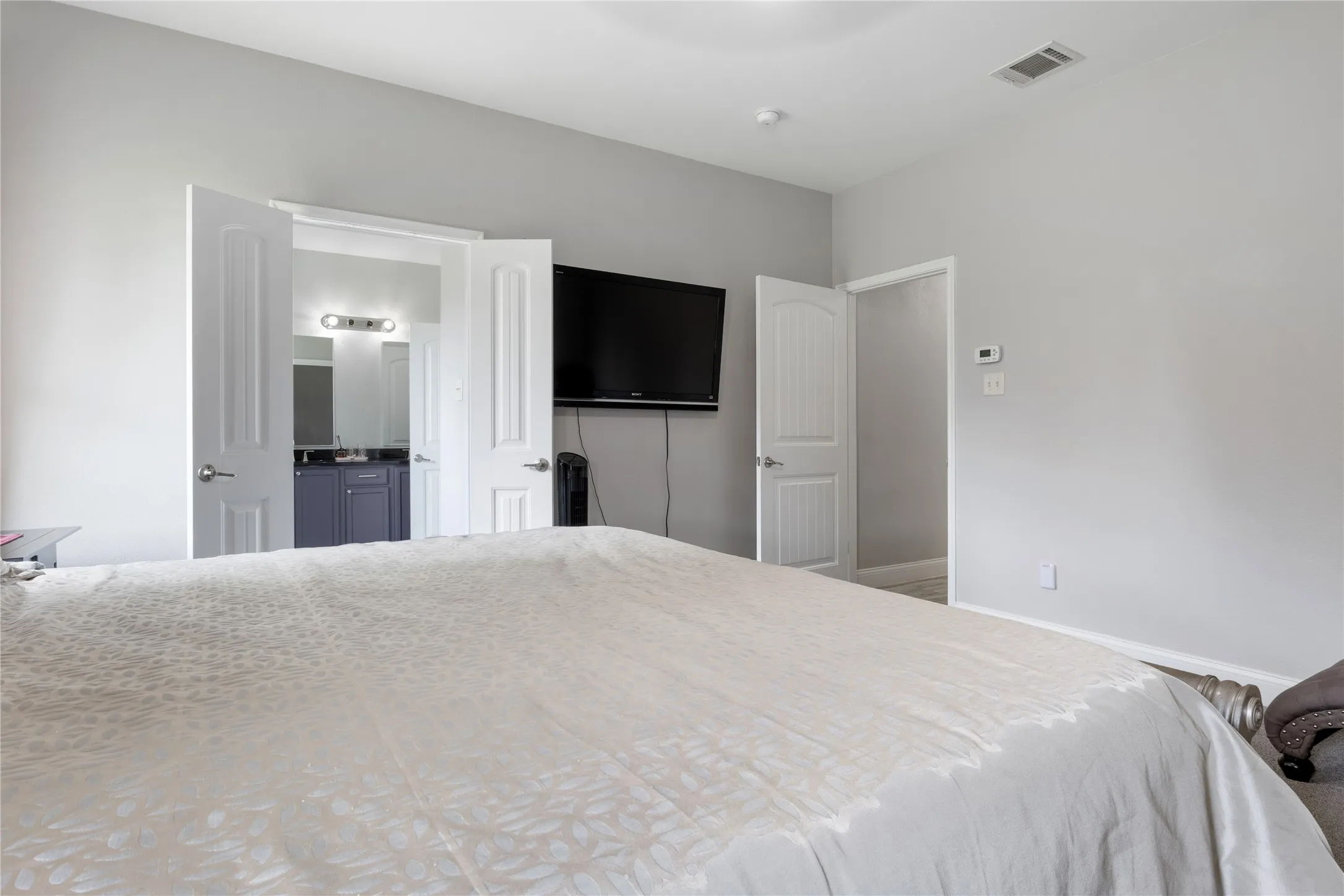 Bedroom with light grey walls and white trim