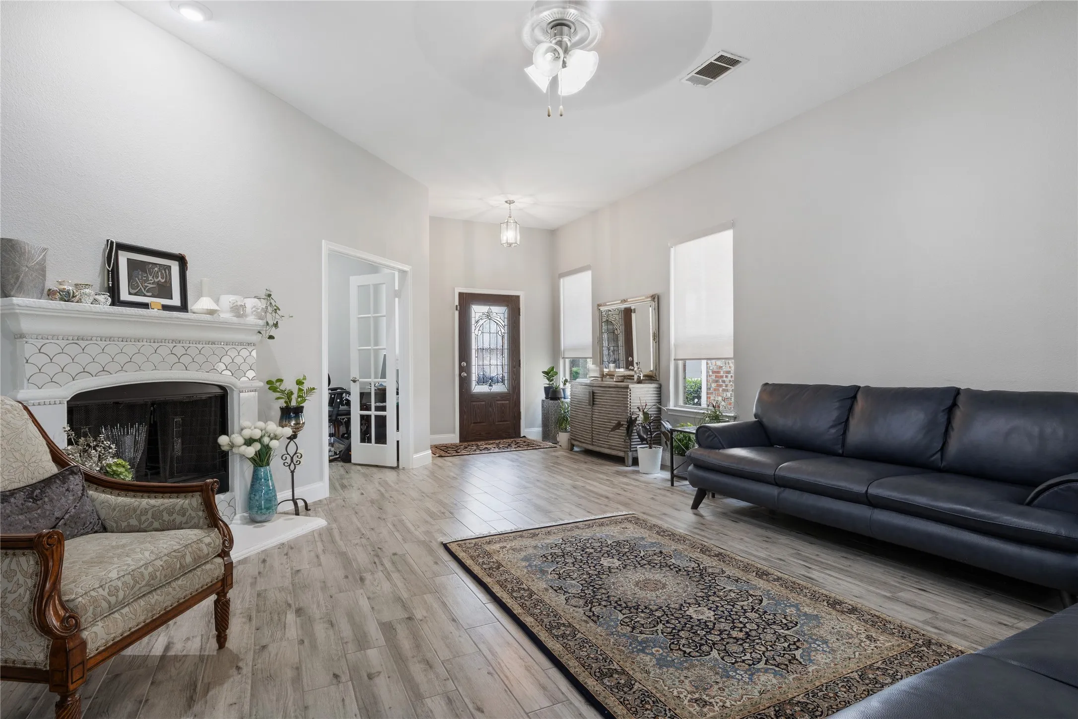 Spacious living area featuring wood-finish flooring and a tiled fireplace