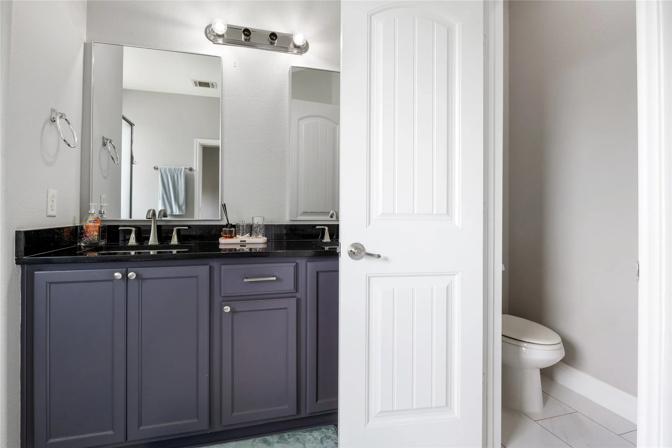 Double vanity with a dark countertop and two undermount sinks