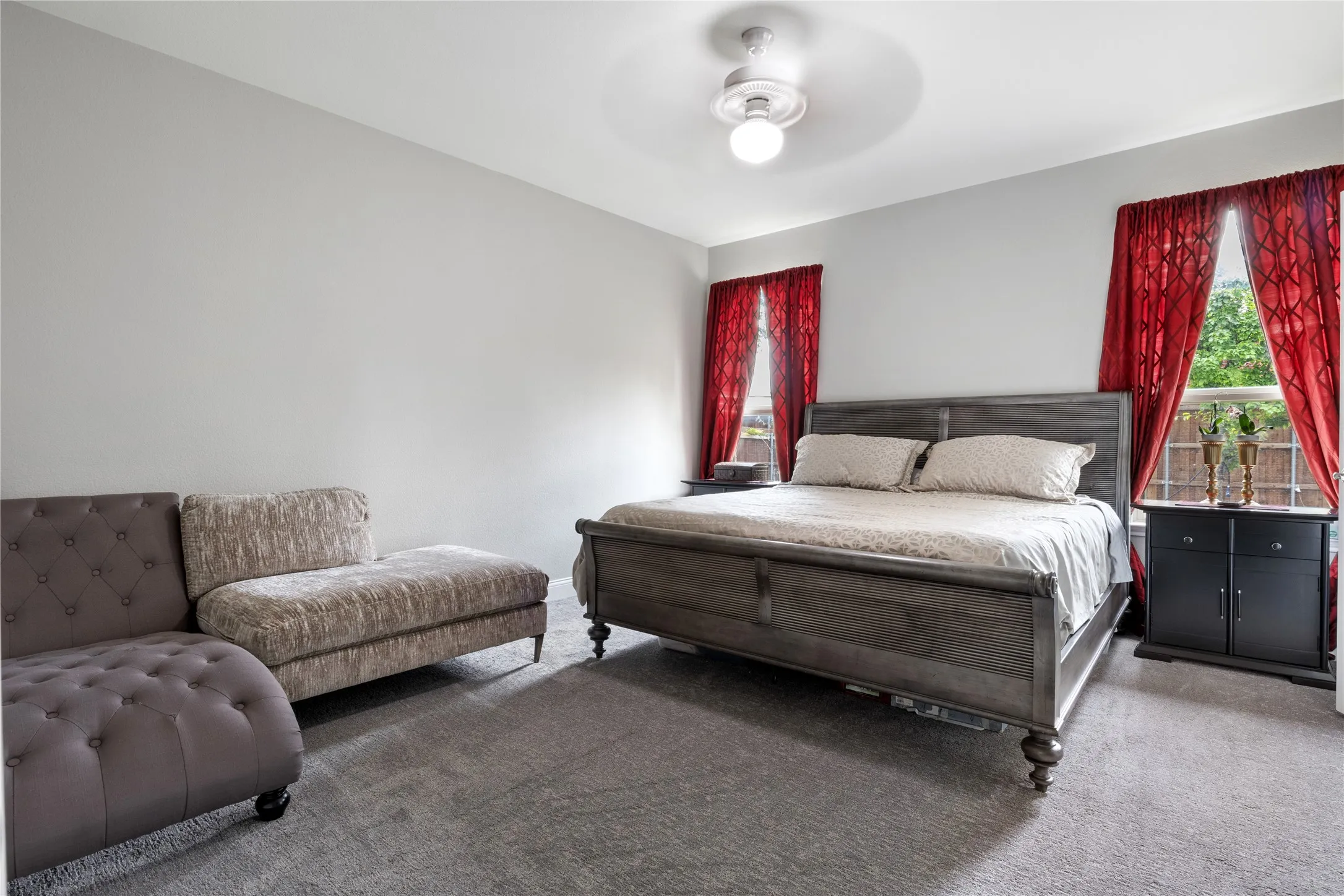 Spacious room with light gray walls and gray carpet flooring