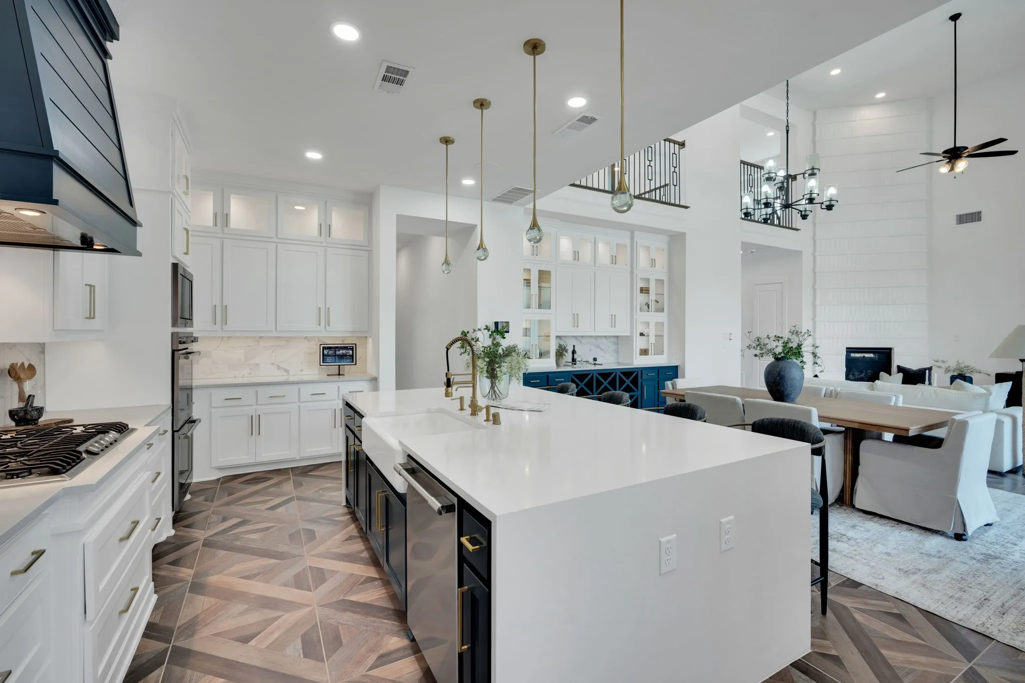 The gold accents, hardware and custom lighting over island- are designer touches!