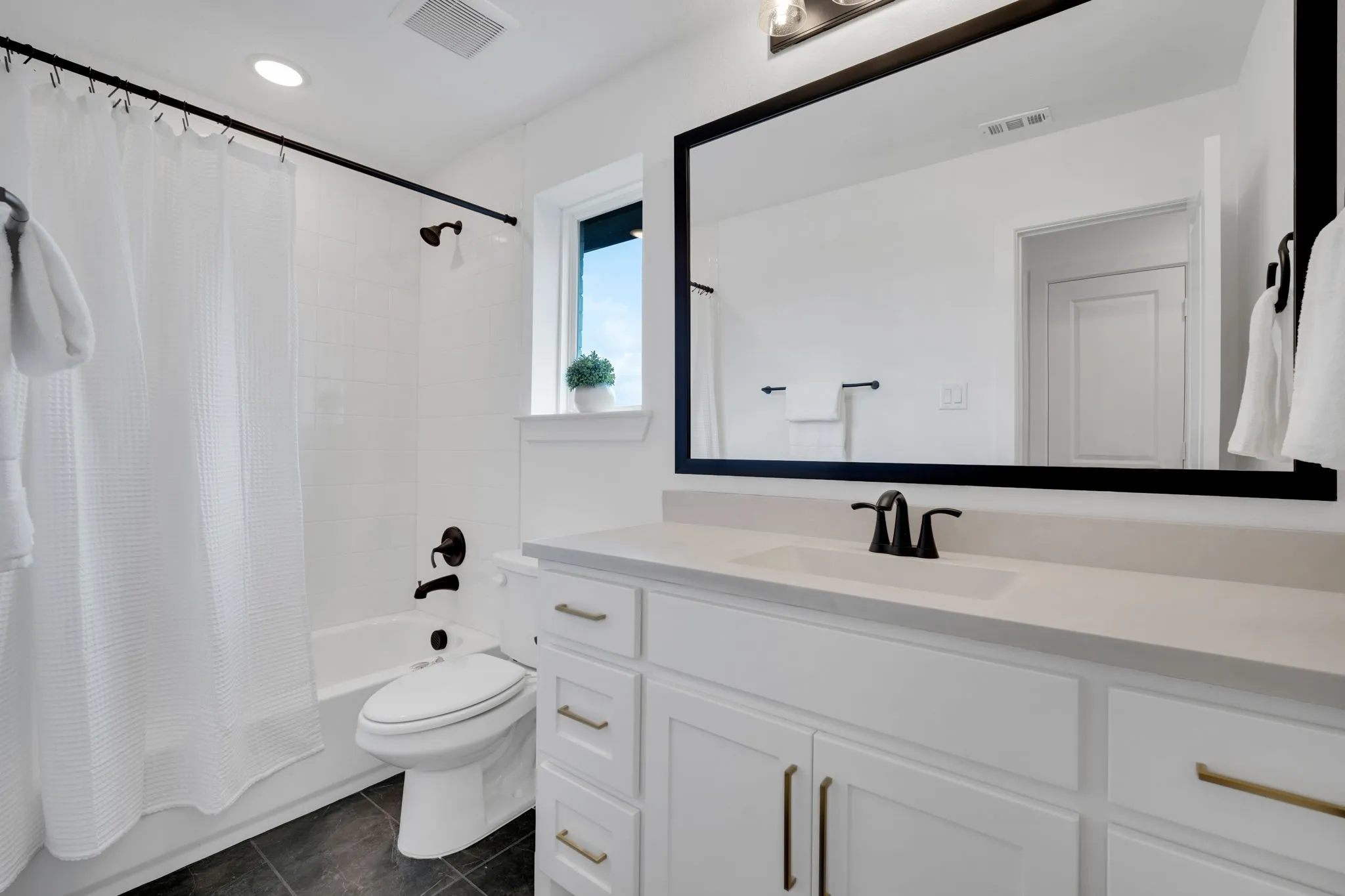 Ensuite bathroom with window.