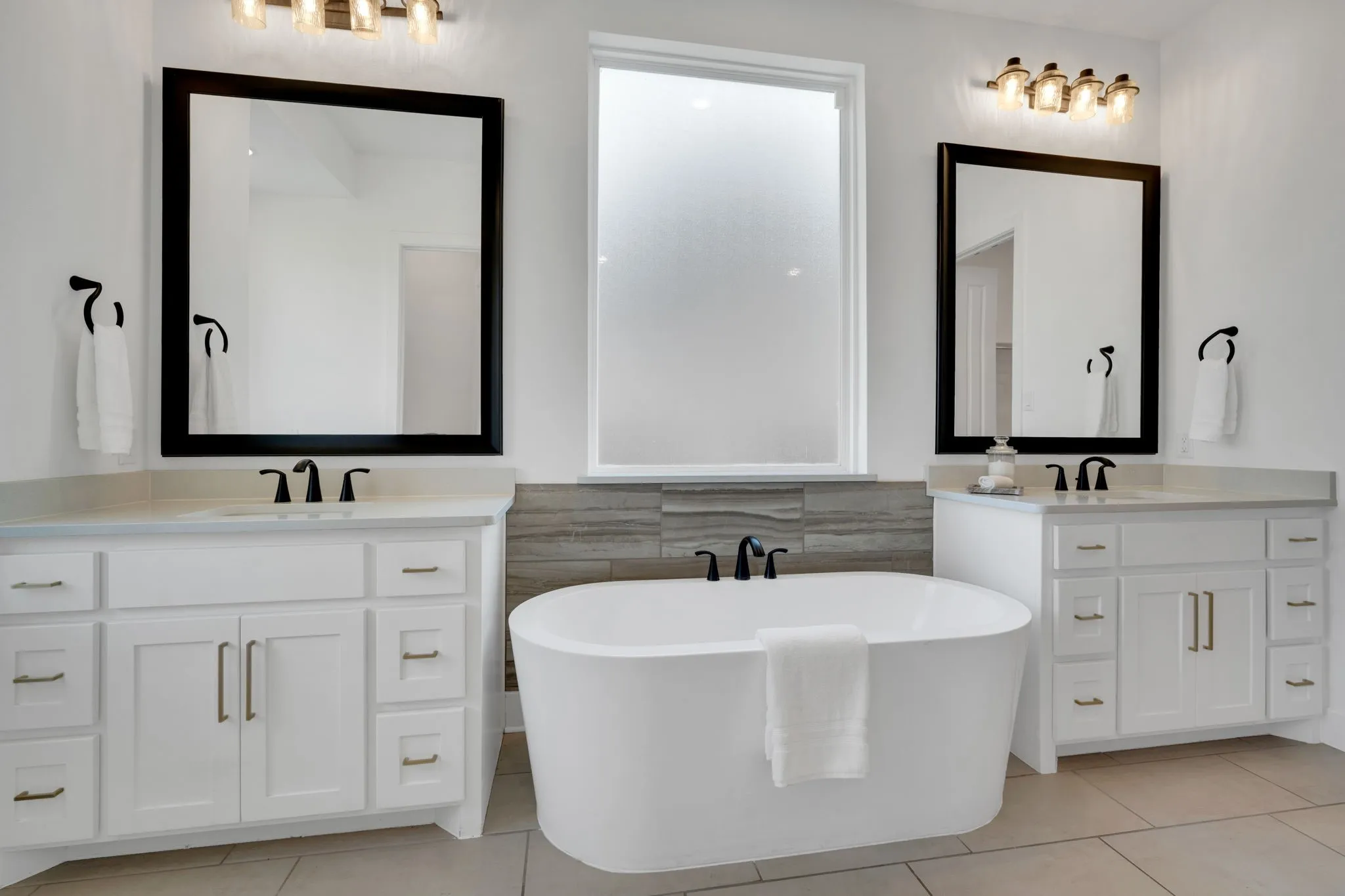 Primary bath has double vanities with sinks and a bonus vanity araa!