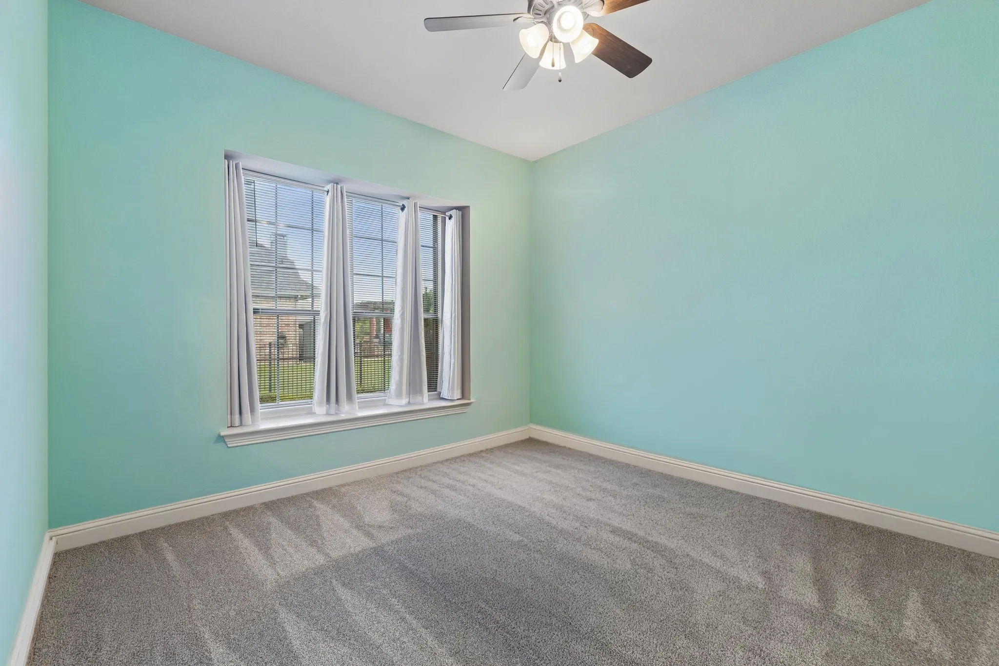 Adjacent to the primary bedroom is spacious secondary bedroom, large window, ceiling fan and a walk-in closet.