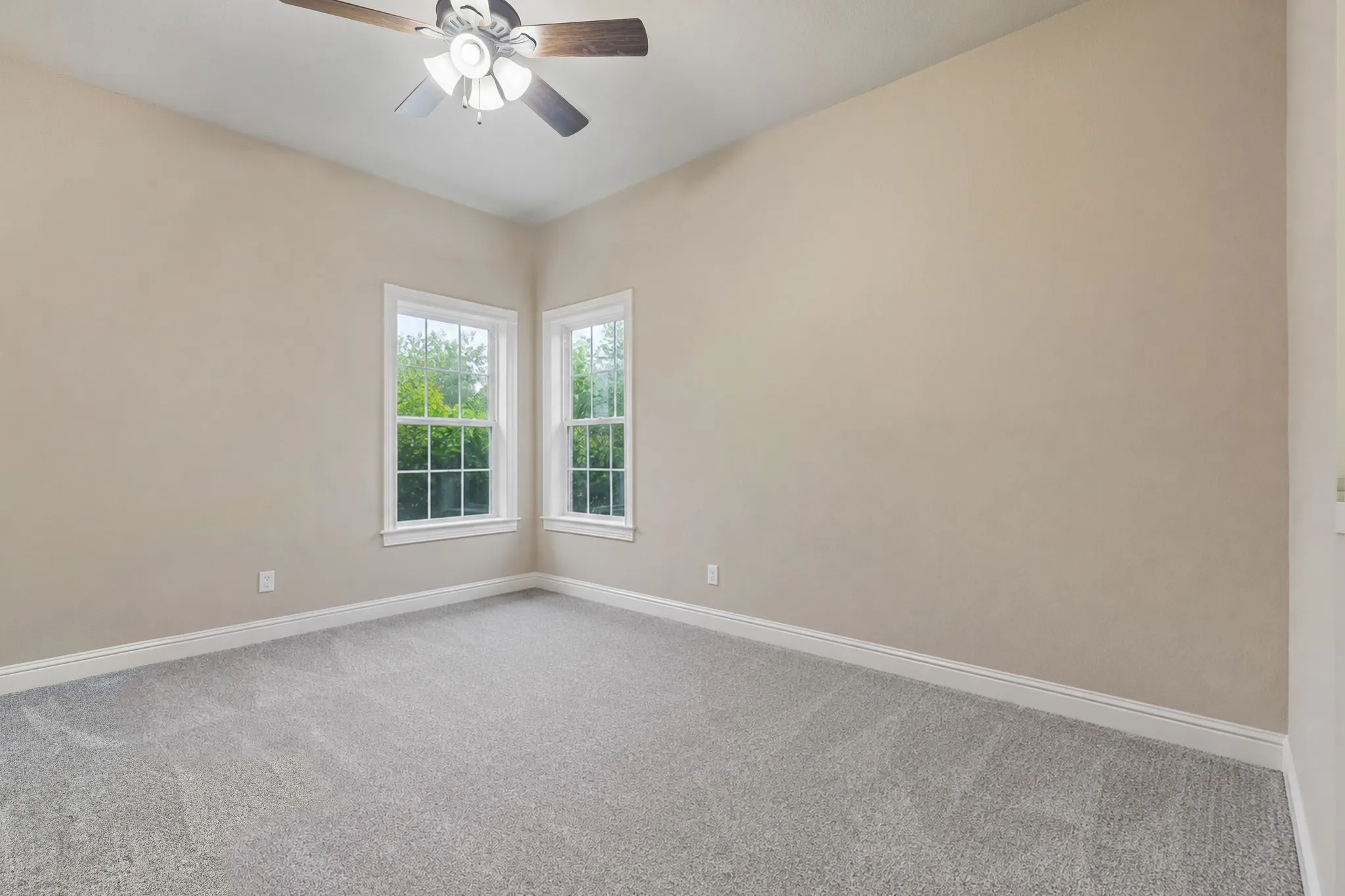 The third secondary bedroom with carpet, ceiling fan, large walk-in closet, bathroom adjacent and a linen closet right outside the door.