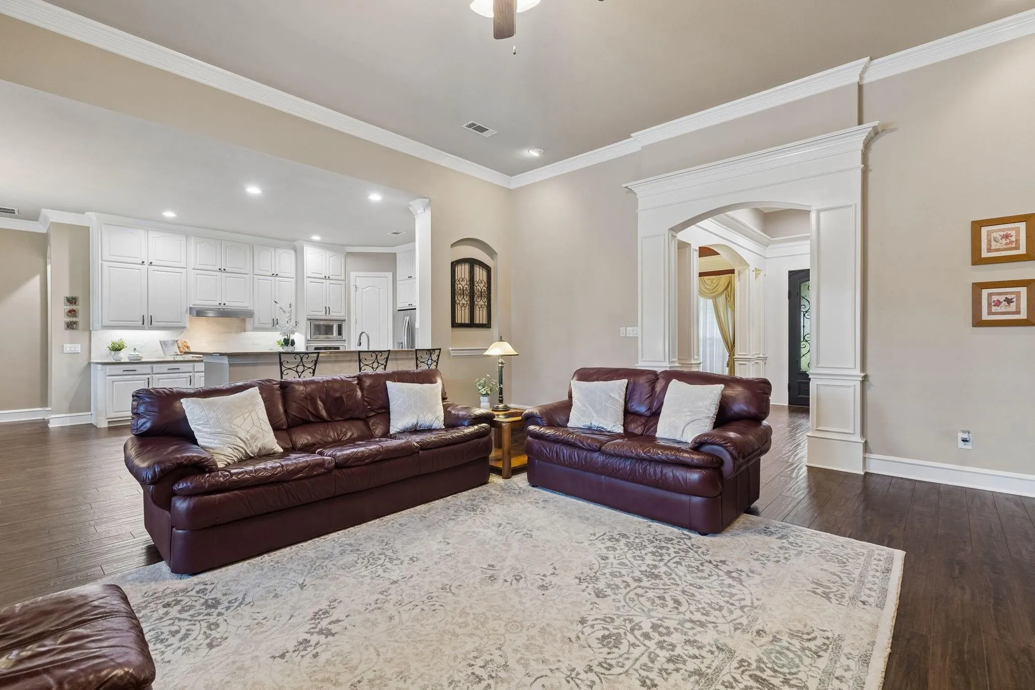 View of the living space flowing seamlessly into the kitchen and entryway.