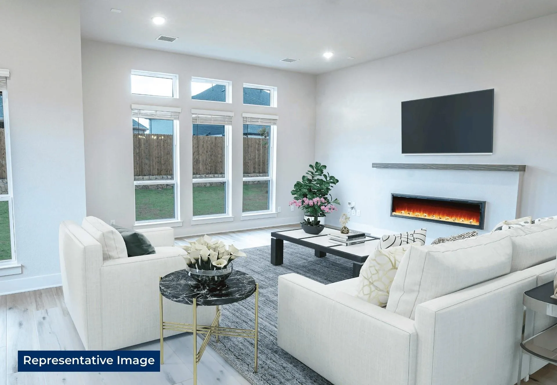 Living room featuring a warm lit fireplace, light wood-type flooring, and recessed lighting