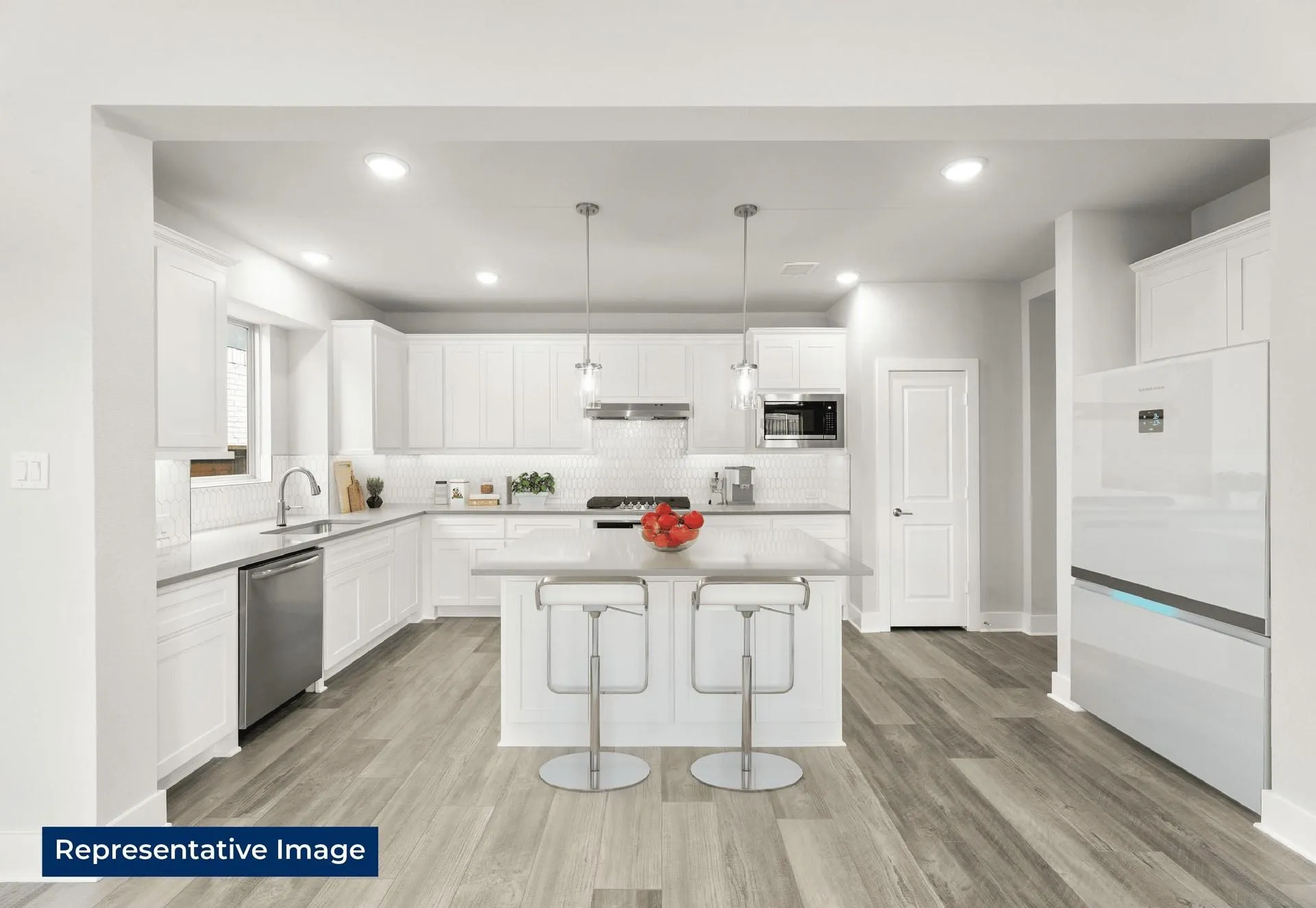 Kitchen with white cabinets, a kitchen bar, light wood-style flooring, a center island, and stainless steel appliances