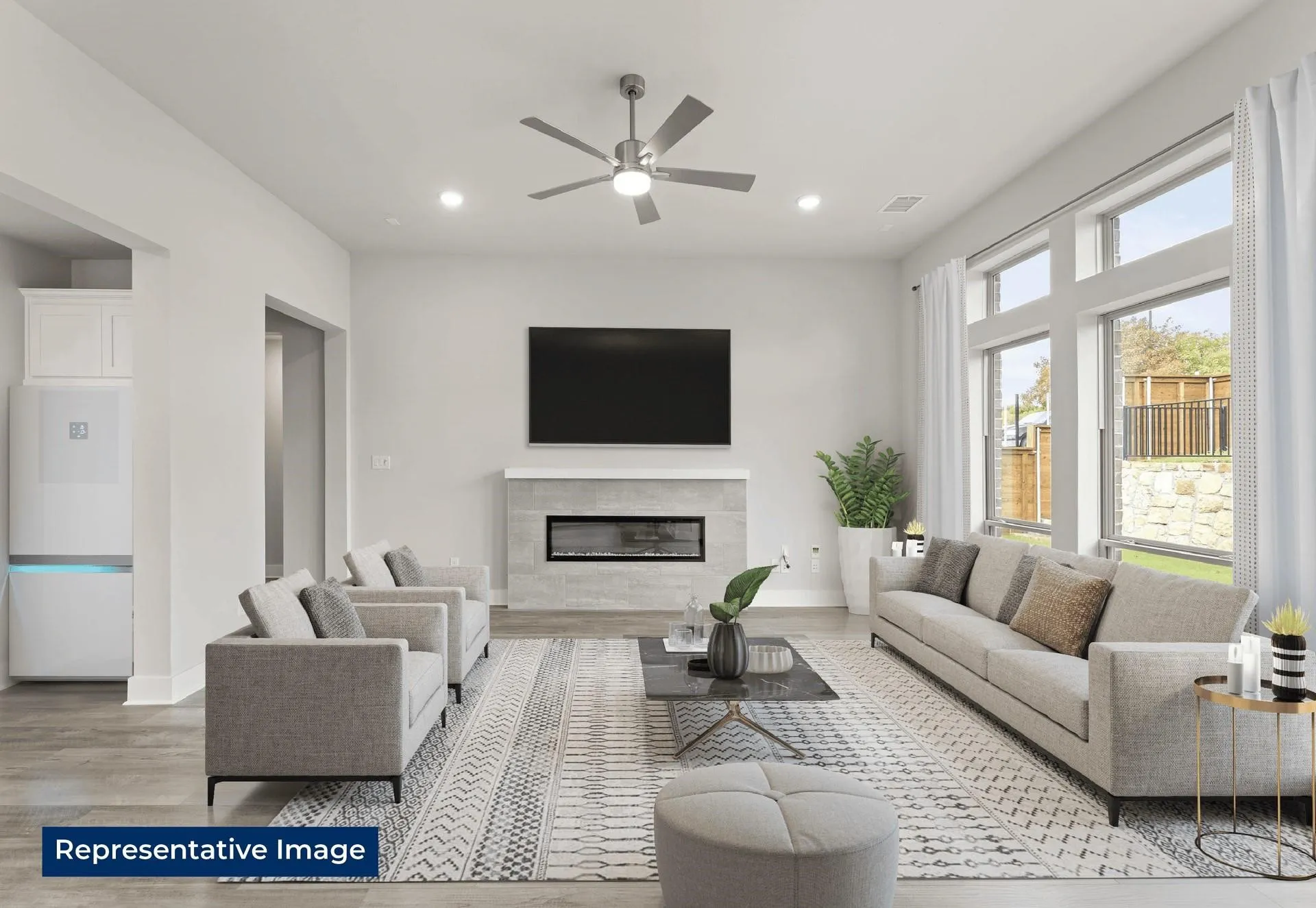 Living area with a ceiling fan, light wood-style floors, a premium fireplace, and recessed lighting