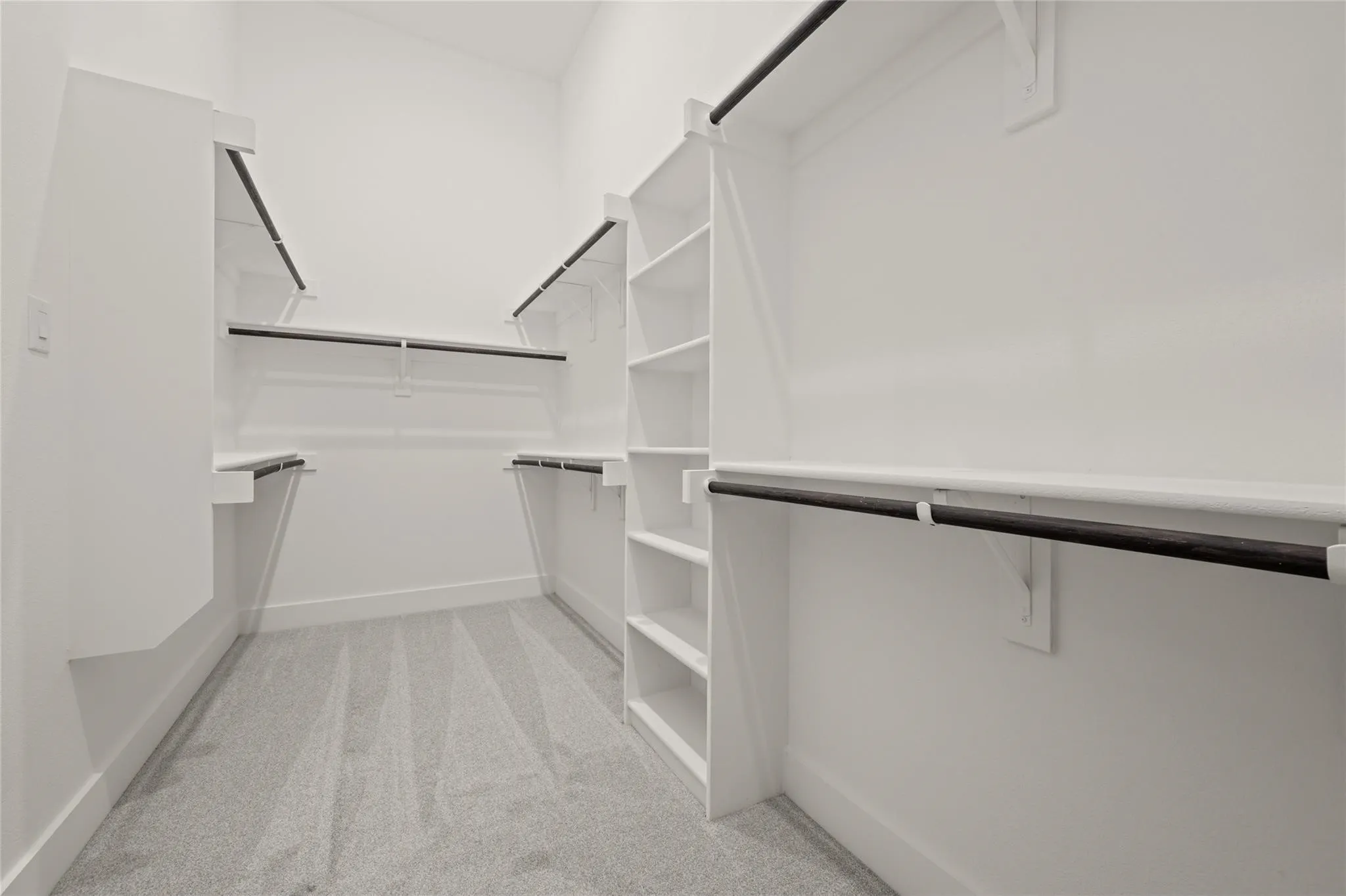 Walk in closet with light carpet