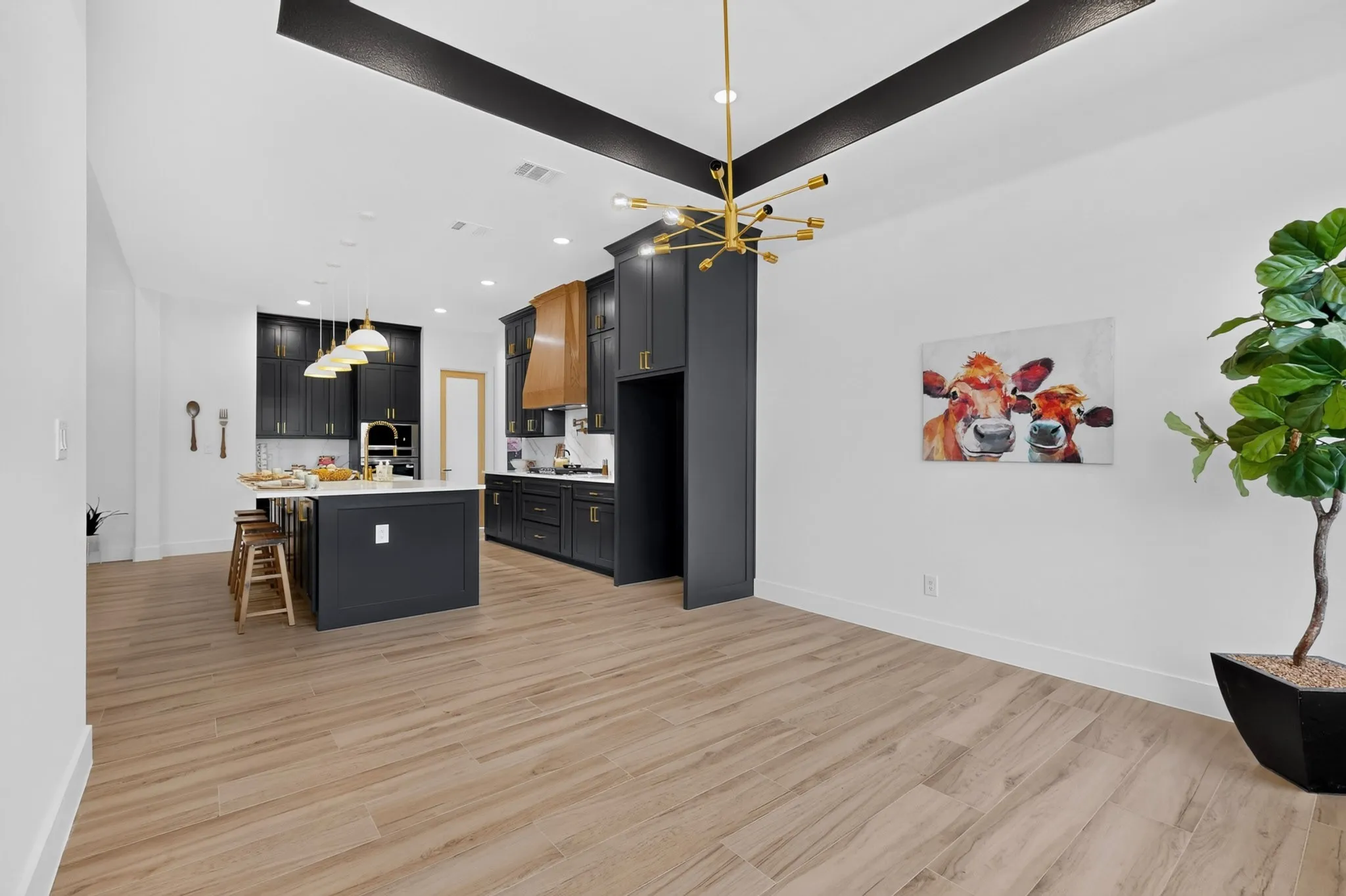 Open-concept kitchen and dining area featuring wood-finish flooring