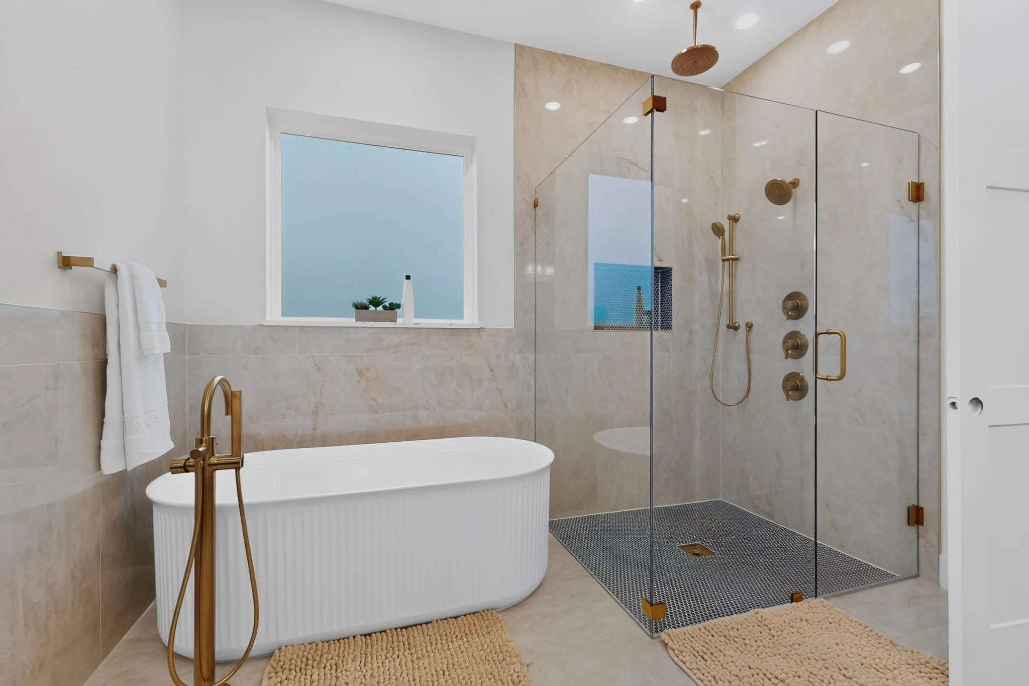 Freestanding soaking tub with a floor-mounted brass faucet